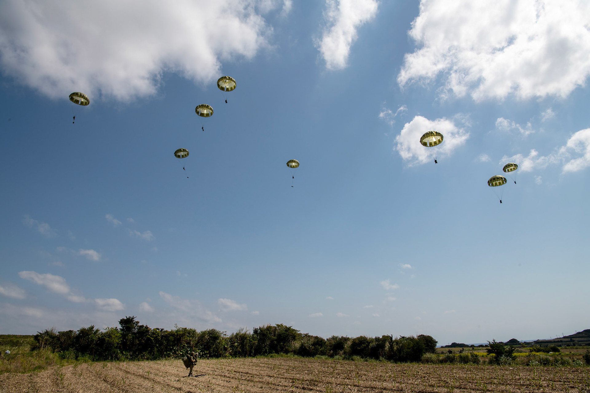 Japan Ground Self-Defense Force paratroopers assigned to the 1st Airborne Brigade descend from a U.S. Air Force C-130J Super Hercules assigned to the 36th Airlift Squadron during Field Training Exercise Iron Fist 23 over Kikaijima Island, Japan, March 3, 2023. During the exercise, the USAF and Japan Self-Defense Forces conducted simulated island seizure airborne operations as the U.S. Marine Corps performed a simultaneous amphibious assault onto the beachhead. (U.S. Air Force photo by Yasuo Osakabe)
