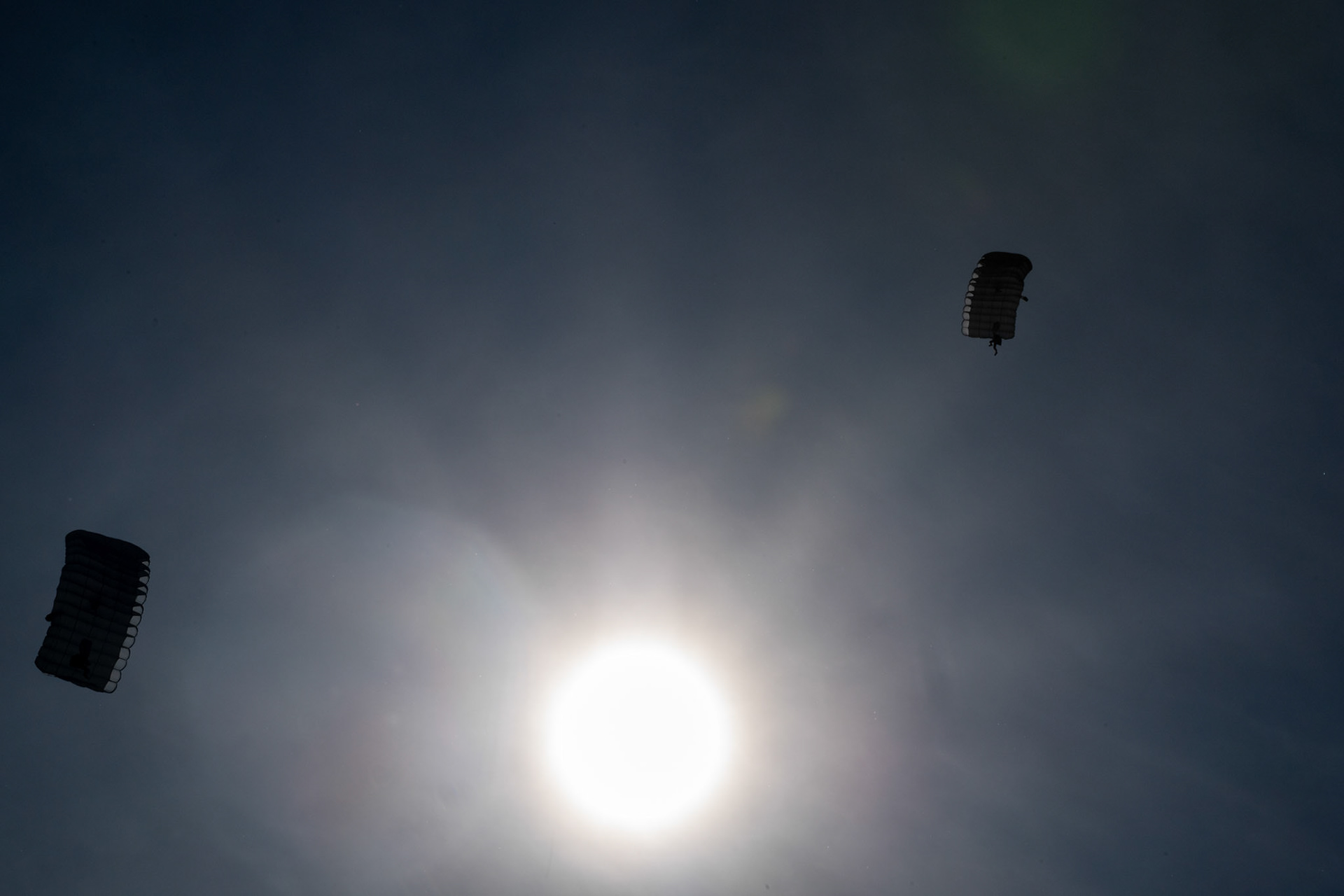 U.S. Navy SEALs (Sea, Air and Land) Team One parachute from a U.S. Air Force C-130J Super Hercules, assigned to the 36th Airlift Squadron over Yokota Air Base, Japan, June 17, 2020, during Exercise Gryphon Jet. Gryphon Jet is an integrated training exercise focused on improving interoperability throughout the special operations community. (U.S. Air Force photo by Yasuo Osakabe)