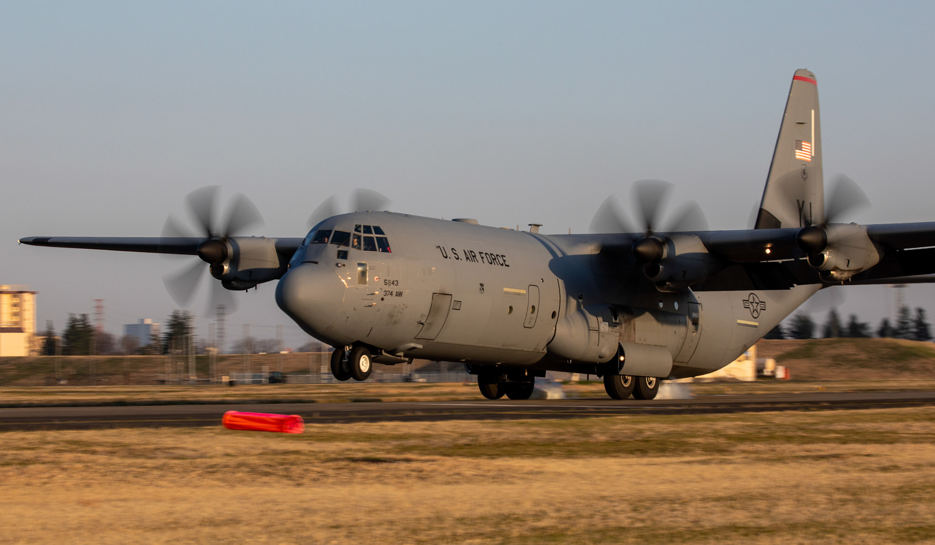 A C-130J Super Hercules assigned to the 36th Airlift Squadron touches down on the Foxtrot taxiway at Yokota Air Base, Japan, March 26, 2020. A C-130J used Foxtrot taxiway here as a landing zone for an assault landing for the first time. Training like this ensures the mission can continue at the Yokota airfield despite any potential setbacks that impact operations to the main runway. (U.S. Air Force photo by Yasuo Osakabe)