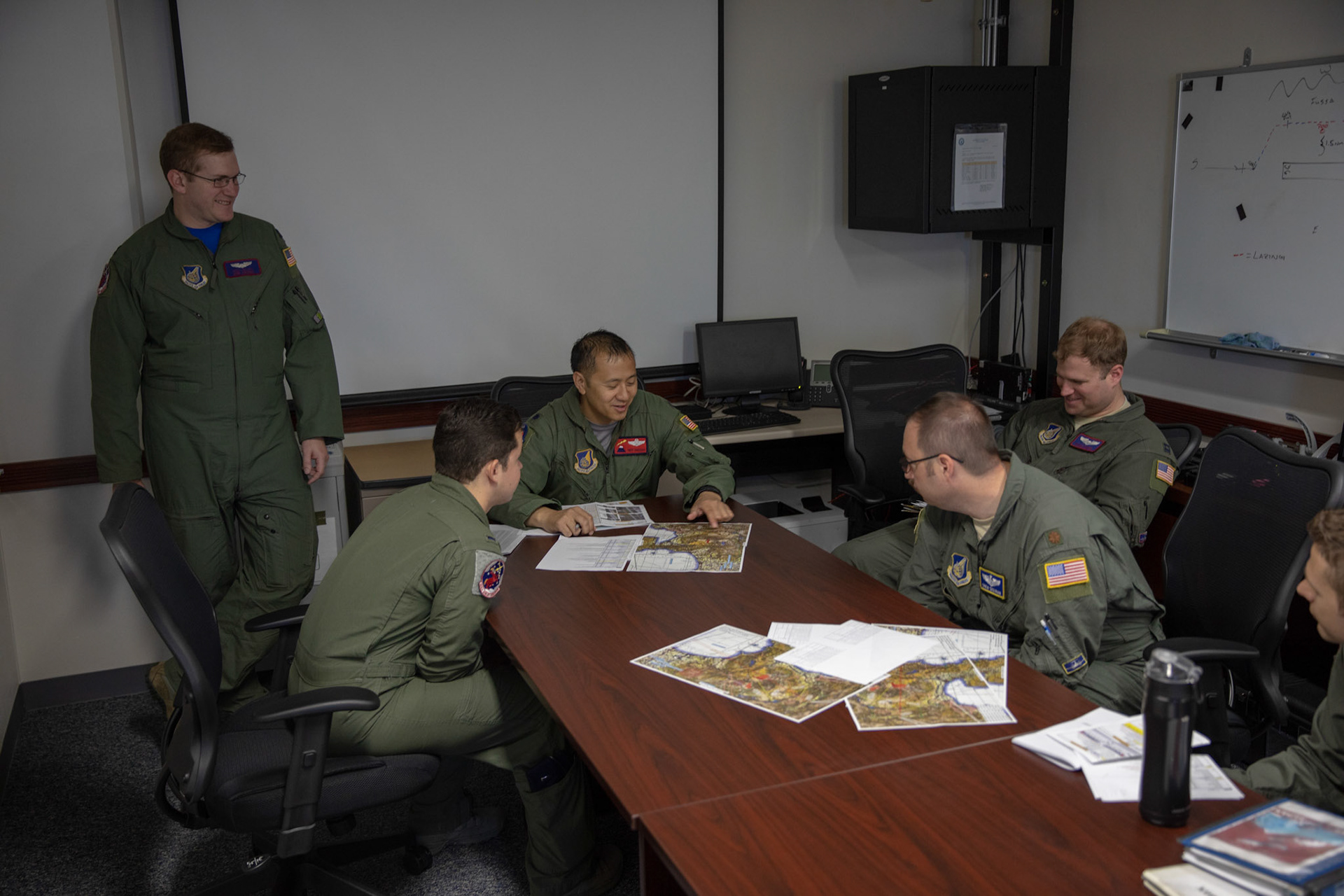 Crewmembers with the 459th Airlift Squadron perform a pre-flight briefing prior to the 374th Airlift Wing (AW) Generation Exercise Elephant Walk at Yokota Air Base, Japan, May 4, 2018. The 374th AW trained its humanitarian aid and disaster relief and formation flying capabilities during the exercise. (U.S. Air Force Photo by Yasuo Osakabe)