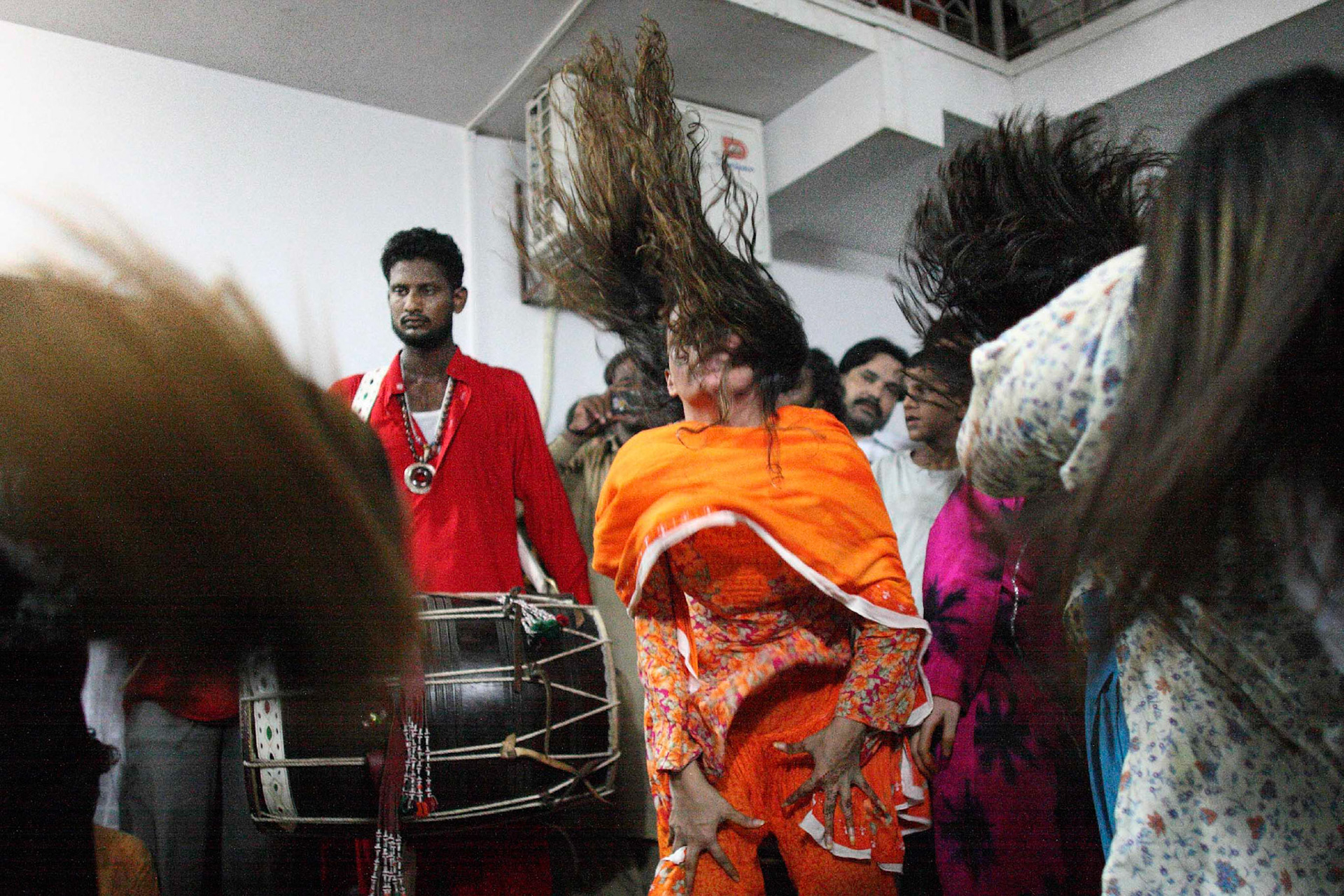 Ladies were swirling their hairs and dancing to beating drums worked themselves into an euphoria. (Travel)