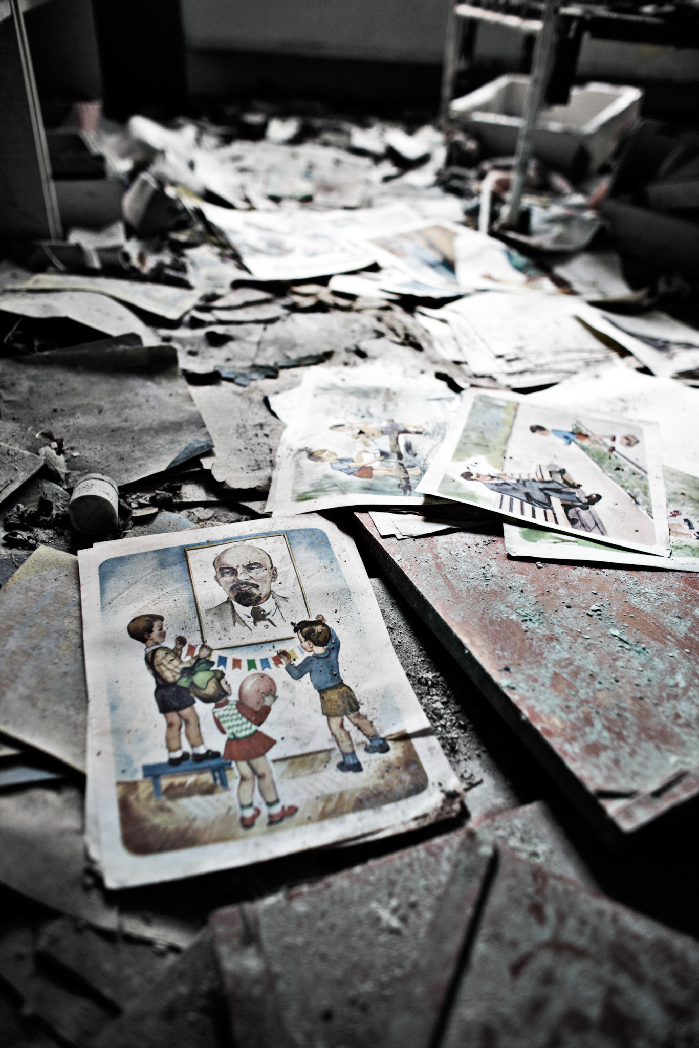 Many Soviet propaganda pictures are scattering on a floor at a kindergarten, Pripyat.