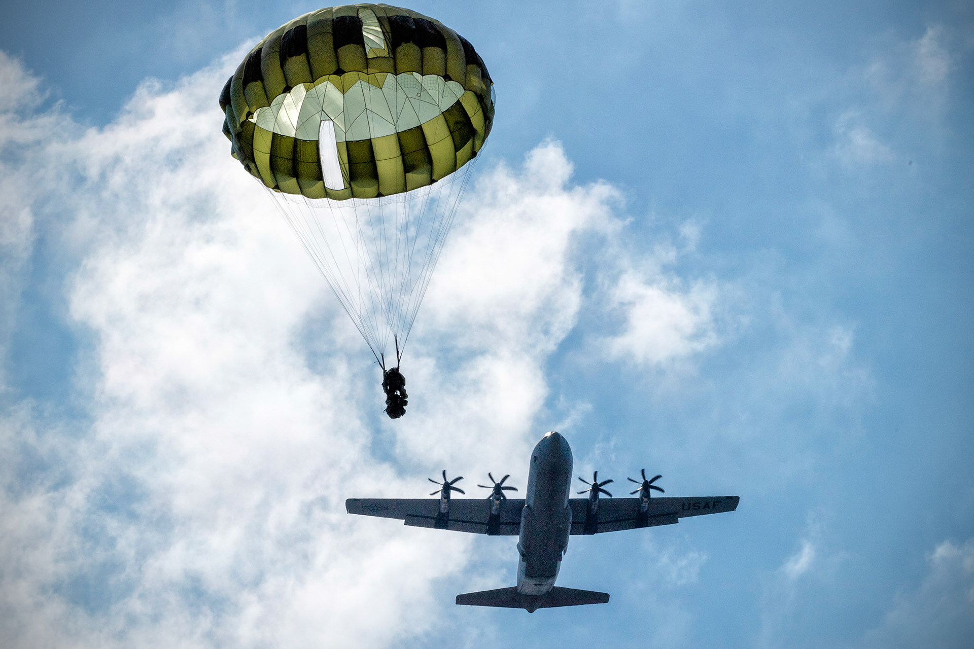 A Japan Ground Self-Defense Force paratrooper assigned to the 1st Airborne Brigade descends from a U.S. Air Force C-130J Super Hercules assigned to the 36th Airlift Squadron during Field Training Exercise Iron Fist 23 over Kikaijima Island, Japan, March 3, 2023. During the exercise, the USAF and Japan Self-Defense Forces conducted simulated island seizure airborne operations as the U.S. Marine Corps performed a simultaneous amphibious assault onto the beachhead. (U.S. Air Force photo by Yasuo Osakabe)