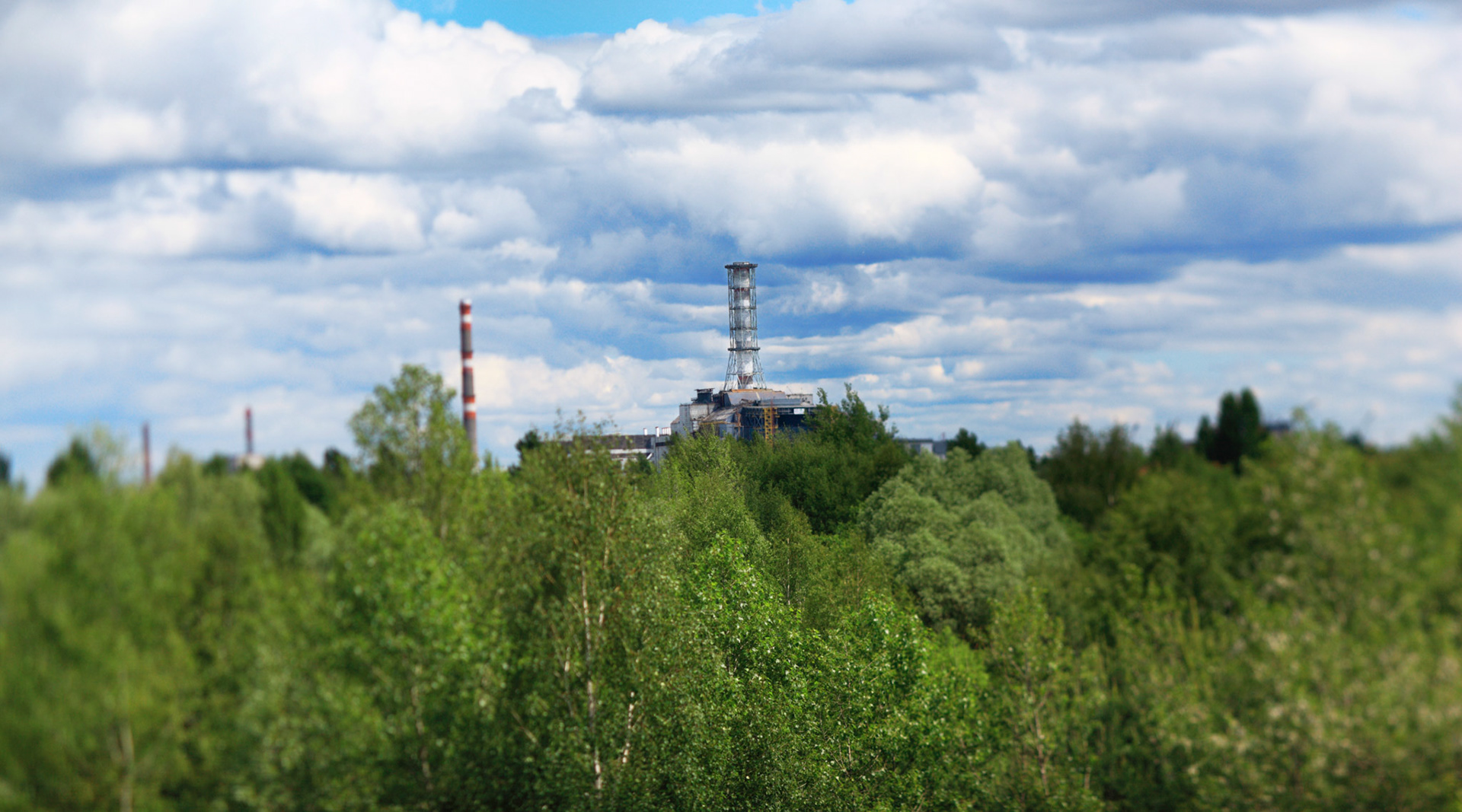 View of the sarcophagus from the railway bridge towards Pripyat city.