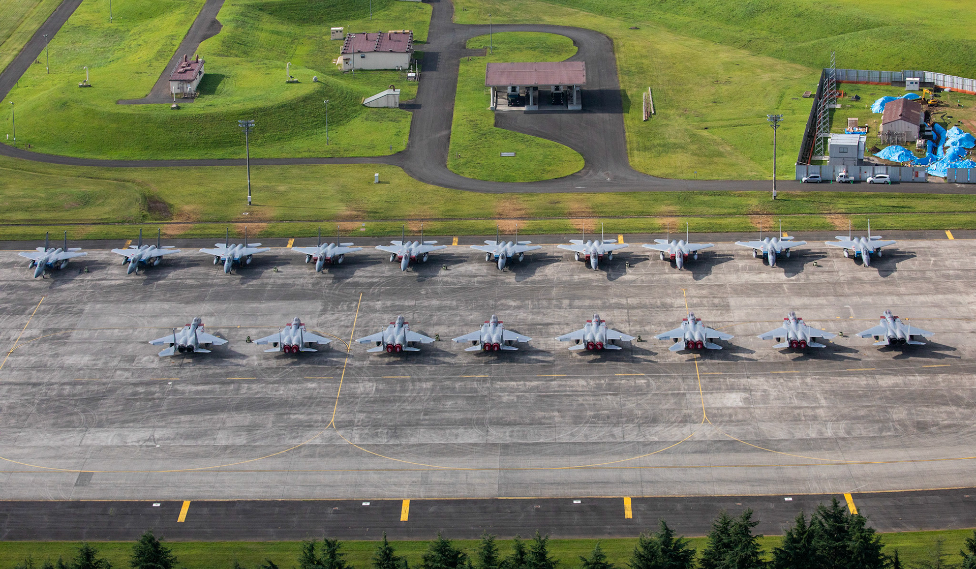 Eighteen U.S. Air Force F-15 Eagles from Kadena Air Base are parked on the ramp, July 9, 2018, at Yokota Air Base, Japan. The F-15s evacuated due to Typhoon Maria. This is the most aircraft to ever evacuate to Yokota AB from Kadena AB. (U.S. Air Force photo by Yasuo Oaskabe)