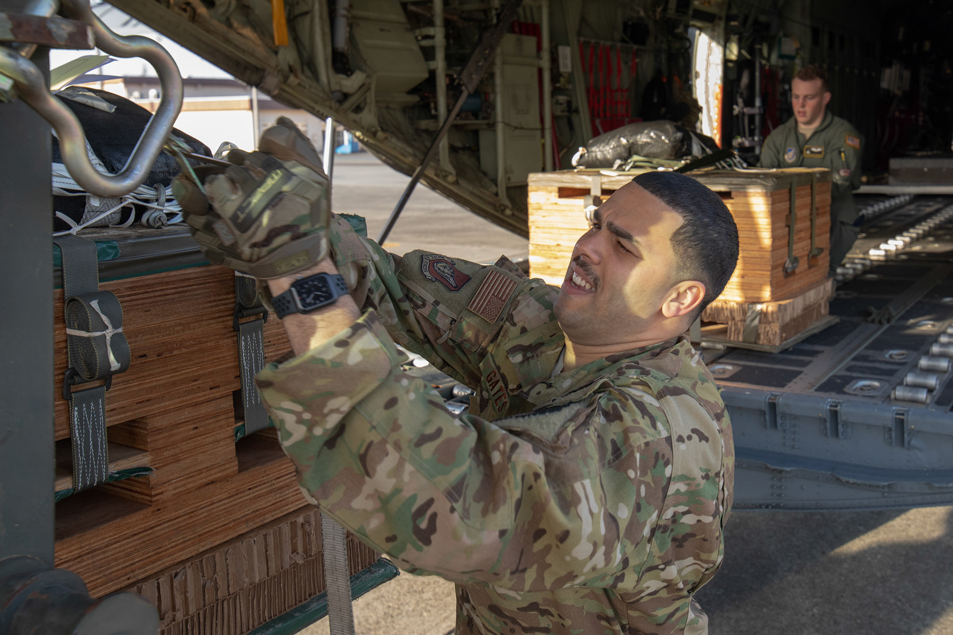 (Front to back) Tech. Sgt. Brian Gates and Airman 1st Class Matthew Pfeffer, 36th Airlift Squadron loadmasters, secure low-cost low-altitude bundles during the Yokota C-130J Rodeo at Yokota Air Base, Japan, March 22, 2019. The flight, airdrop, and offload were a part of the Rodeo competition in which pilots and loadmasters are graded on their ability to execute their skillsets both accurately and expeditiously. (U.S. Air Force photo by Yasuo Osakabe)