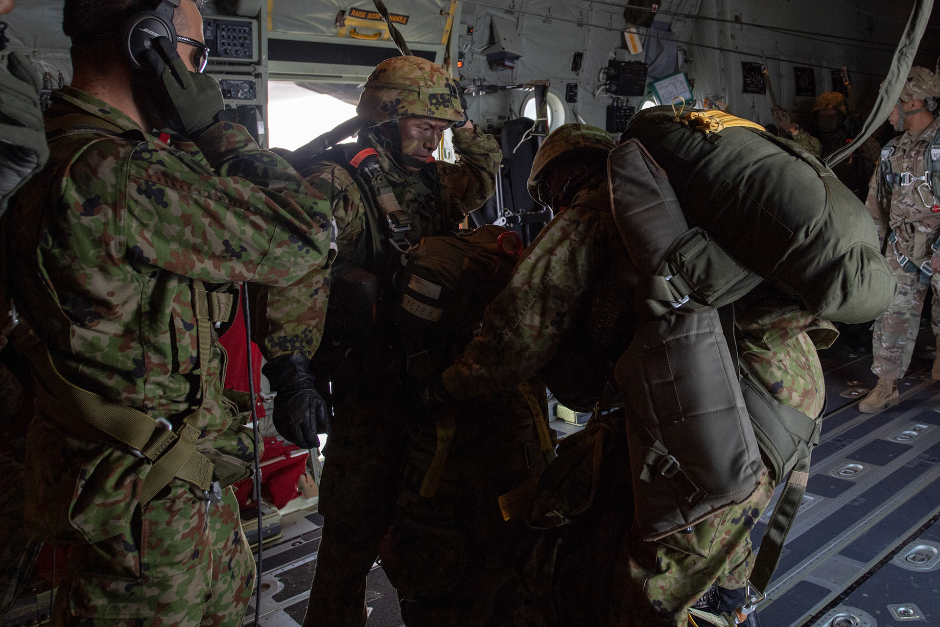 Japan Ground Self-Defense Force soldiers assigned to the 1st Airborne Brigade check their gear before conducting a jump from a U.S. Air Force C-130J Super Hercules assigned to the 36th Airlift Squadron over Hiju-dai drop zone, Oita prefecture, Japan, Nov. 4, 2018, during Keen Sword 19. Approximately 280 JGSDF personnel conducted jump training from U.S. Air Force C-130J Super Hercules’ for the first time in Japan. (U.S. Air Force photo by Yasuo Osakabe)