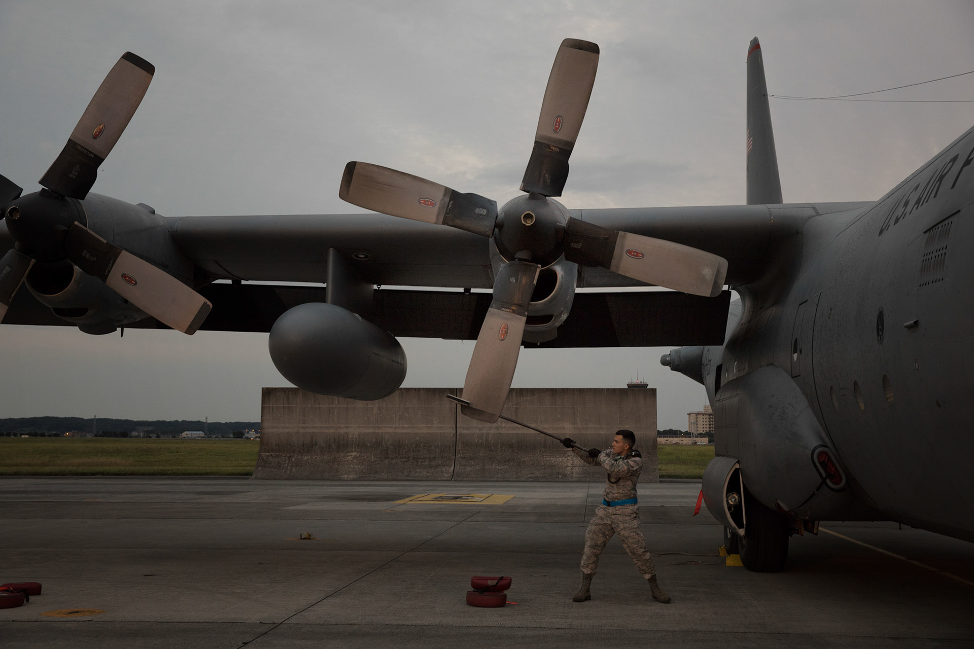 A crew chief from the 374th Aircraft Maintenance Squadron uses a prop stick to make sure the NO.2 blade is positioned in the T-position to prevent leaks on a C-130H Hercules at Yokota Air Base, Japan, Oct. 5, 2017. Crew members with the 36th Airlift Squadron completed the last active-duty C-130H tactical training sortie. (U.S. Air Force photo by Yasuo Osakabe)