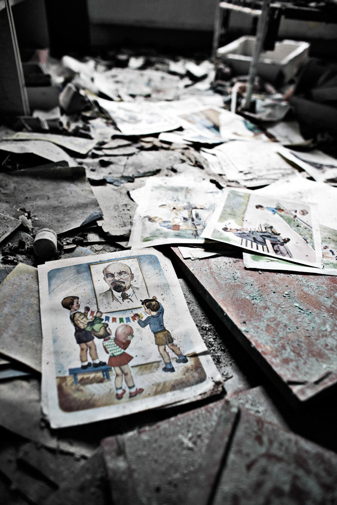 Many Soviet propaganda pictures is scatters on a floor at a kindergarten, Pripyat.