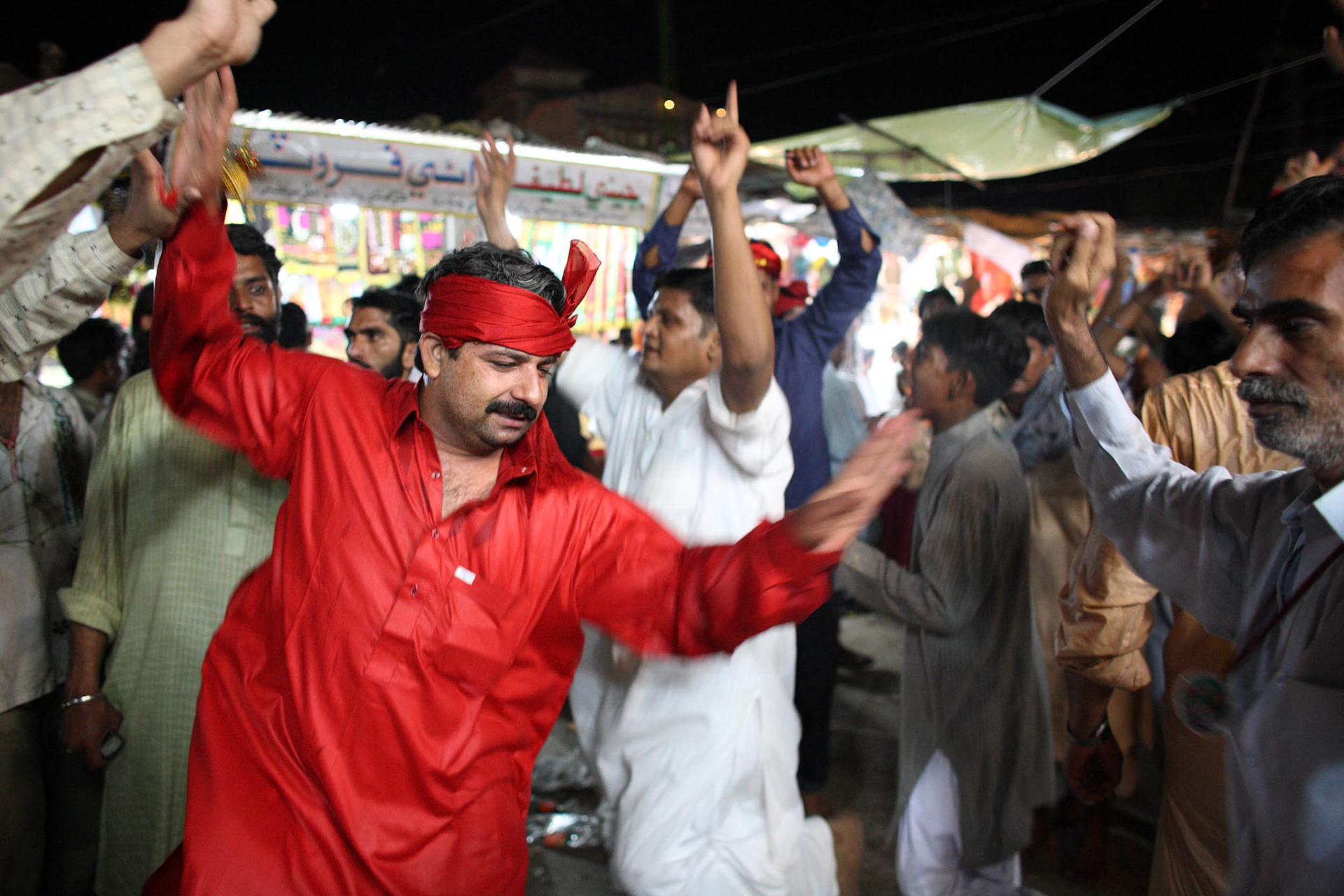 Devotees were danceing in praise of the saint by the approach to the tomb of Lal Shahbaz Qalandar. (Travel)