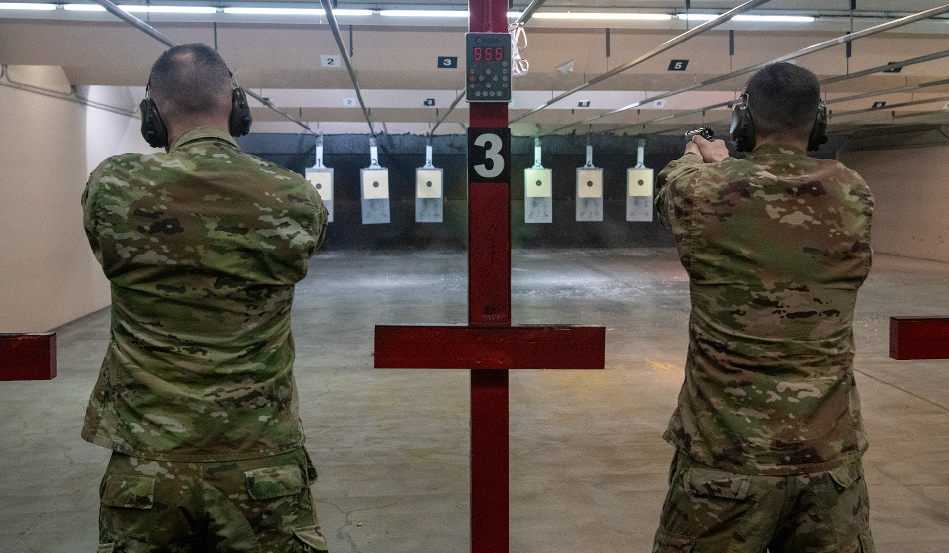 Participants shoot M9 Beretta pistols during an Excellence-In-Competition M9 pistol event at Yokota Air Base, Japan, April 12, 2022. The four-day competition was held to boost morale and test 165 active-duty military members on how accurate they can shoot their authorized duty pistols. The top 10% scorers will earn the Air Force Excellence In Competition medal to wear on the Service Dress Uniform. (U.S. Air Force photo by Yasuo Osakabe)