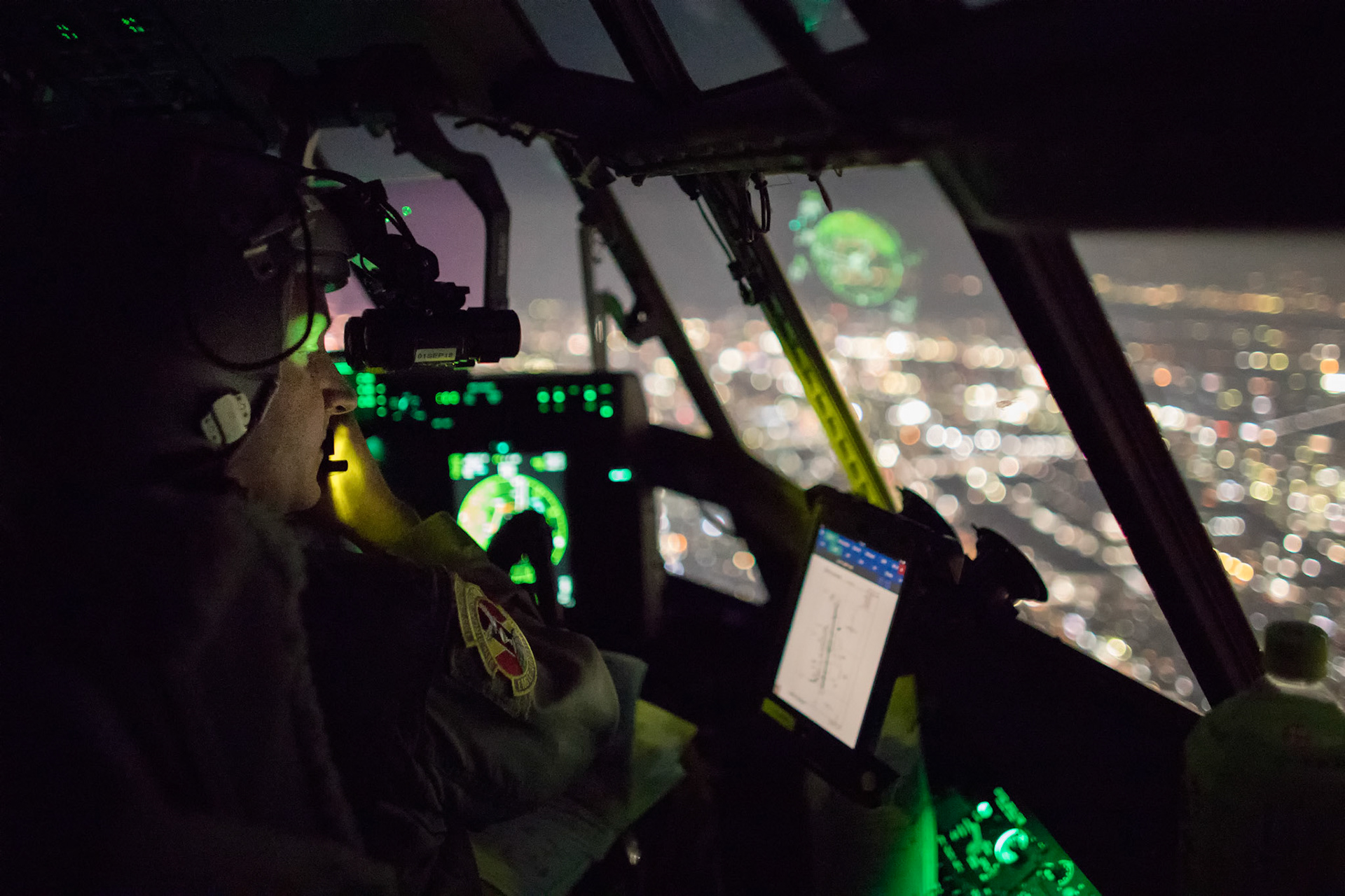 Maj. Christopher Carlen, 36th Airlift Squadron C-130J pilot, performs a visual confirmation with night vision goggles during a training mission ver the Kanto Plain, Japan, March 26, 2018. Yokota aircrews regularly conduct night flying operations to ensure they are prepared for a variety of contingencies throughout the Indo-Asia Pacific region. (U.S. Air Force photo by Yasuo Osakabe)