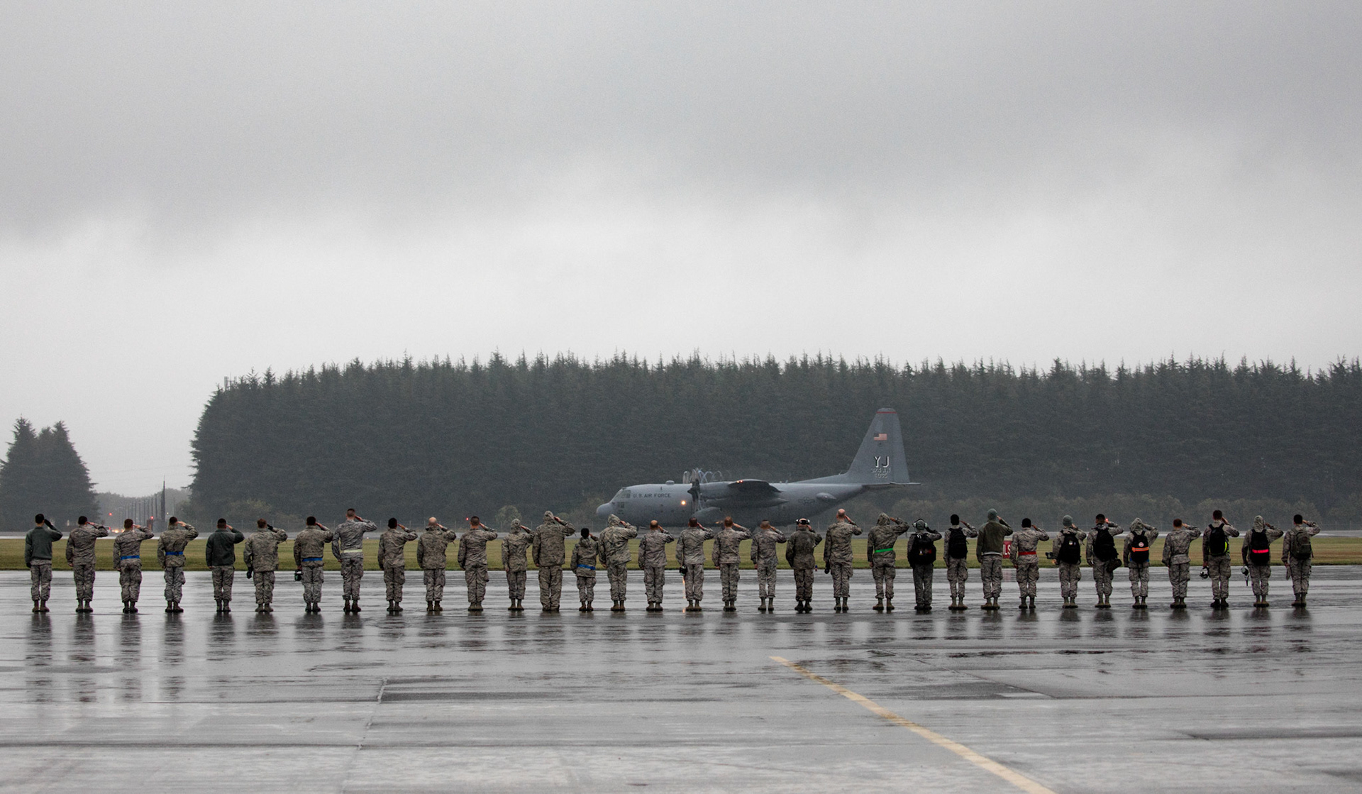 Members with the 374th Aircraft Maintenance Squadron salute the last C-130H Hercules departing from Yokota Air Base, Japan, Oct. 16, 2017. Yokota was the last active-duty location to operate the C-130H. The 374th AMXS maintained 14 C-130H Hercules aircraft, which were responsible for the tactical airlift of an area of responsibility covering 50 percent of the globe. (U.S. Air Force photo by Yasuo Osakabe)