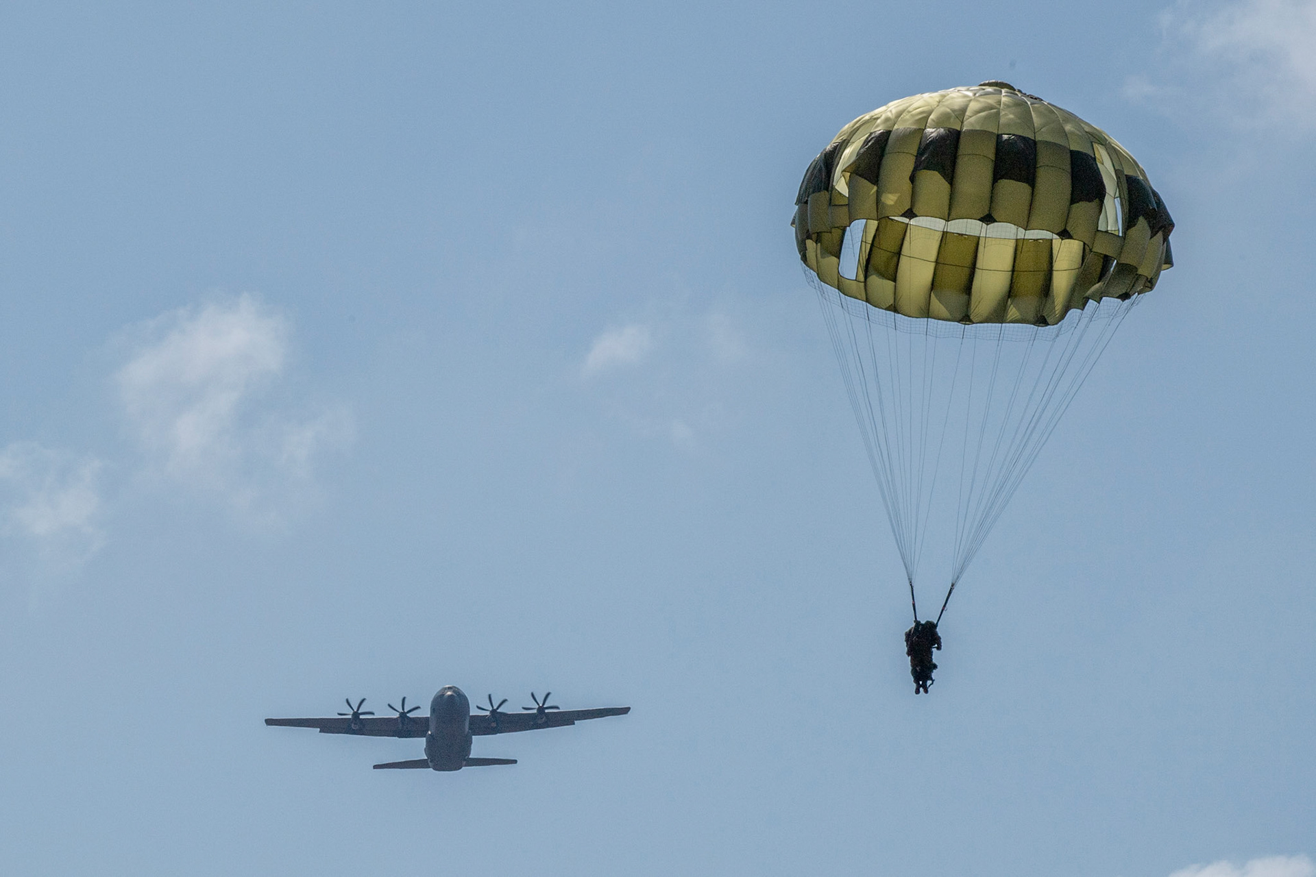 A Japan Ground Self-Defense Force paratrooper assigned to the 1st Airborne Brigade descends from a U.S. Air Force C-130J Super Hercules assigned to the 36th Airlift Squadron during Field Training Exercise Iron Fist 23 over Kikaijima Island, Japan, March 3, 2023. During the exercise, the USAF and Japan Self-Defense Forces conducted simulated island seizure airborne operations as the U.S. Marine Corps performed a simultaneous amphibious assault onto the beachhead. (U.S. Air Force photo by Yasuo Osakabe)