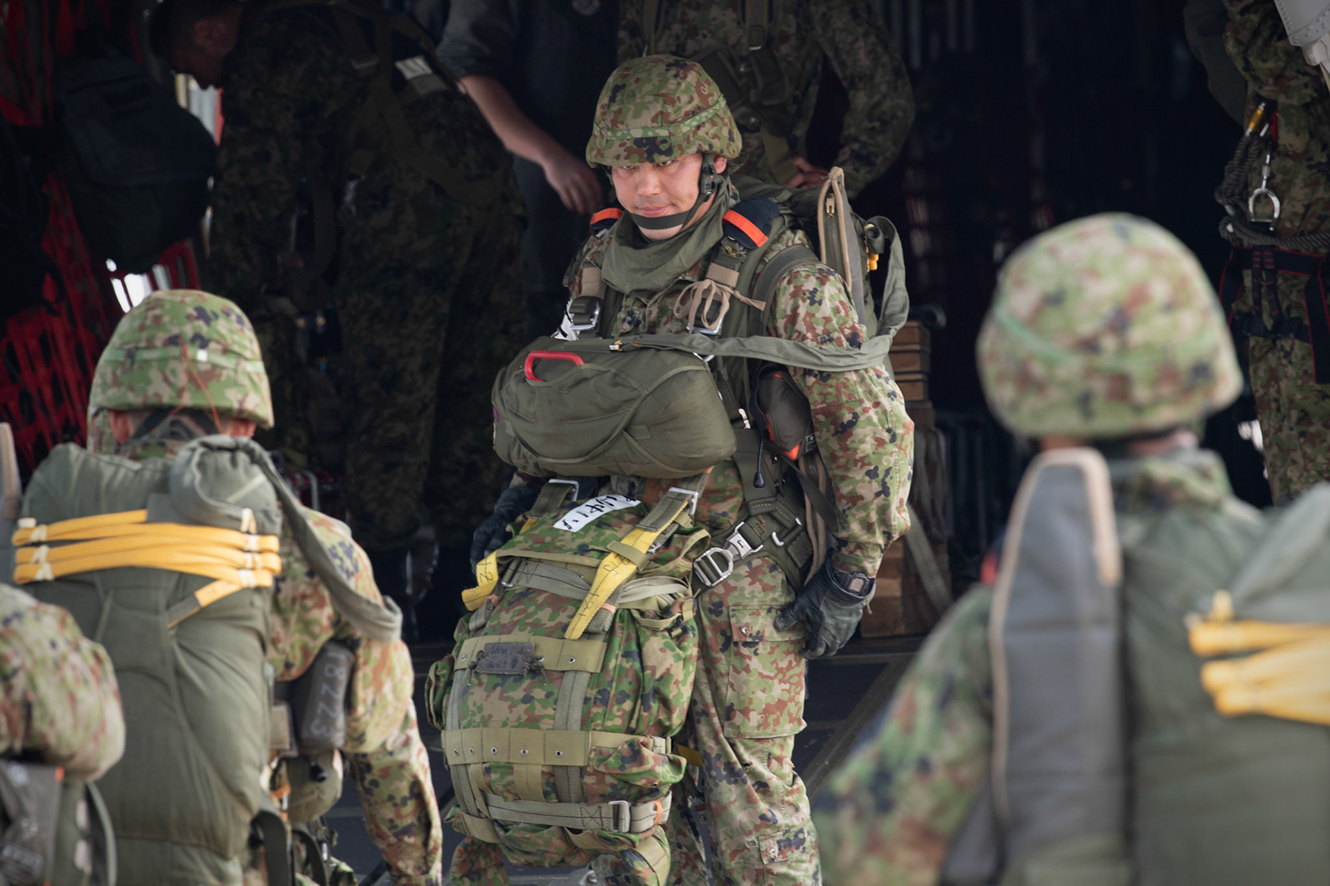 A Japan Ground Self-Defense Force soldier assigned to the 1st Airborne Brigade, direct the boarding on a U.S. Air Force C-130J Super Hercules assigned to the 36th Airlift Squadron at Japan Air Self-Defense Force Tsuiki Air Base, Japan, July 16, 2019, during a bilateral jump training. The training allows USAF and JGSDF units to work alongside each other while improving the readiness of our armed forces. (U.S. Air Force photo by Yasuo Osakabe)