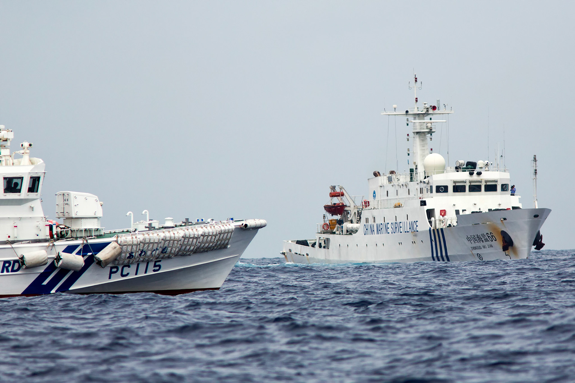 SENKAKU ISLANDS, Japan -- Japanese Coast Guard vessel, left, sails along with Chinese maritime surveillance ship Haijian No. 66, right, at Uotsuri-jima, Japan, May 26, 2013. Chinese government ships entered into the Japanese territorial waters of 46 times. (Photo by Osakabe Yasuo)