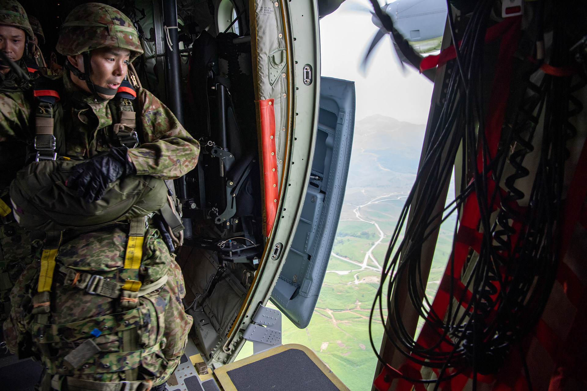 A Japan Ground Self-Defense Force soldier assigned to the 1st Airborne Brigade jumps from a U.S. Air Force C-130J Super Hercules from the 36th Airlift Squadron over Hiju-dai exercise area, Oita prefecture, Japan, July 16, 2019, during a bilateral jump training. The training allows USAF and JGSDF units to work alongside each other while improving the readiness of our armed forces. (U.S. Air Force photo by Yasuo Osakabe)