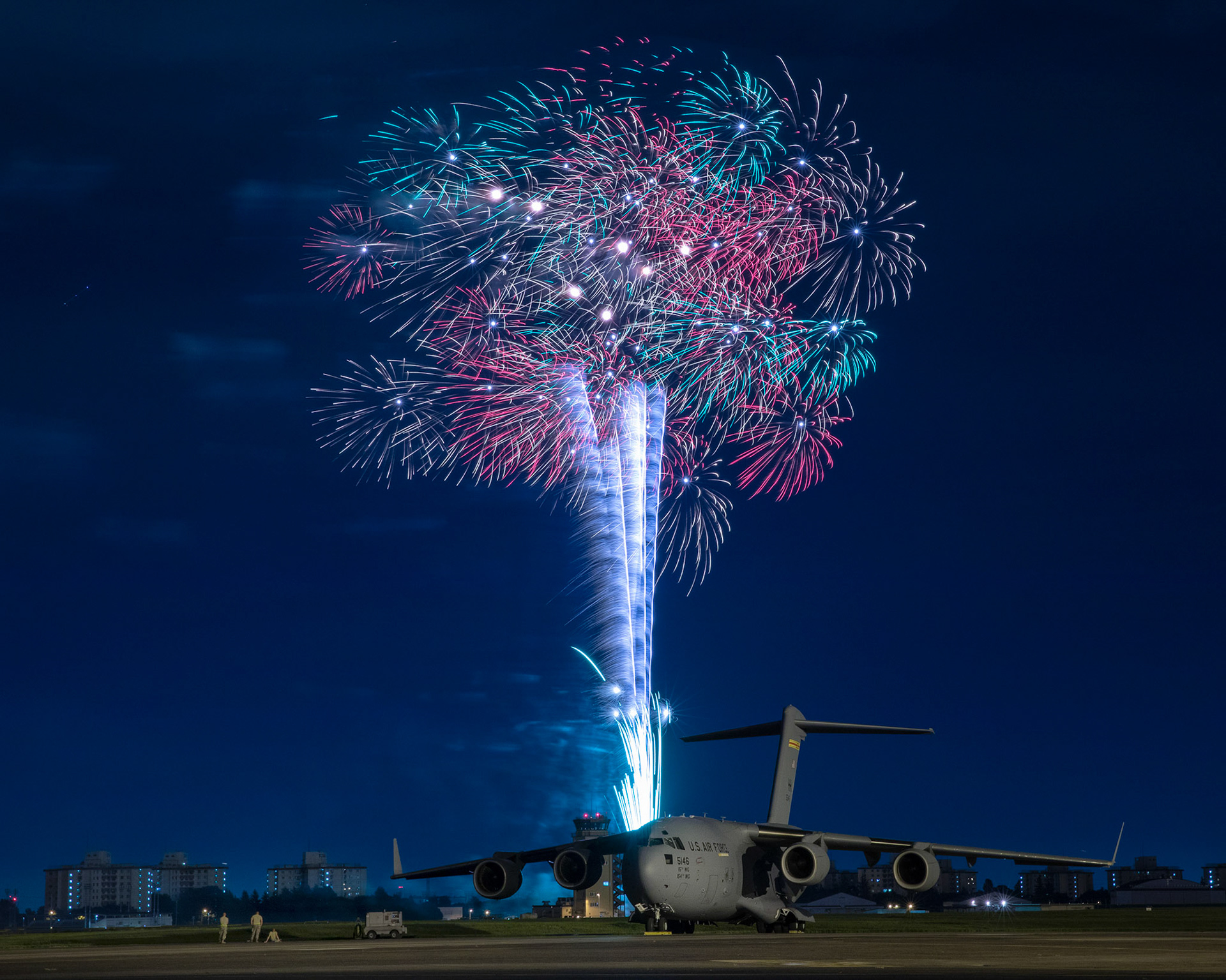 Fireworks explode behind a U.S. Air Force C-17 Globemaster III aircraft assigned to the 15th Wing during Celebrate America, July 3, 2018, at Yokota Air Base, Japan. Celebrate America is an annual event that provides military members and their families the opportunity to enjoy games, food and bands before culminating in a fireworks display over the Yokota AB airfield to celebrate Independence Day. (U.S. Air Force photo by Yasuo Osakabe)