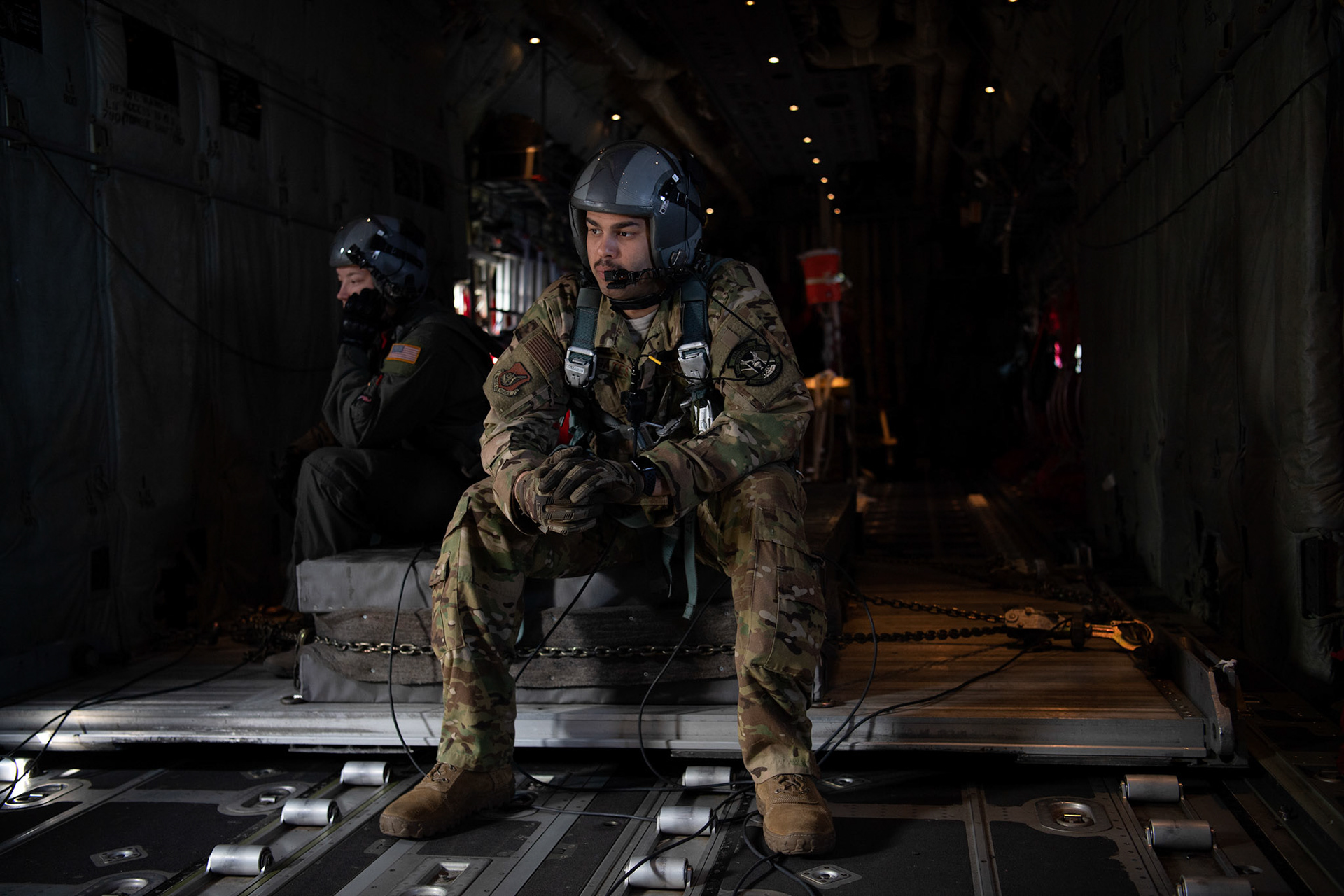 Tech. Sgt. Brian Gates, 36th Airlift Squadron C-130J loadmaster, speaks on the radio with crewmembers over the Kanto Plain, March 22, 2019, during the Yokota C-130J Rodeo. The Rodeo is a tactical airlift competition between flights within the 36th Airlift Squadron and 374th Operations Support Squadron, whose goal is to demonstrate capabilities, improve procedures, and enhance standardization for global operations.  (U.S. Air Force photo by Yasuo Osakabe)