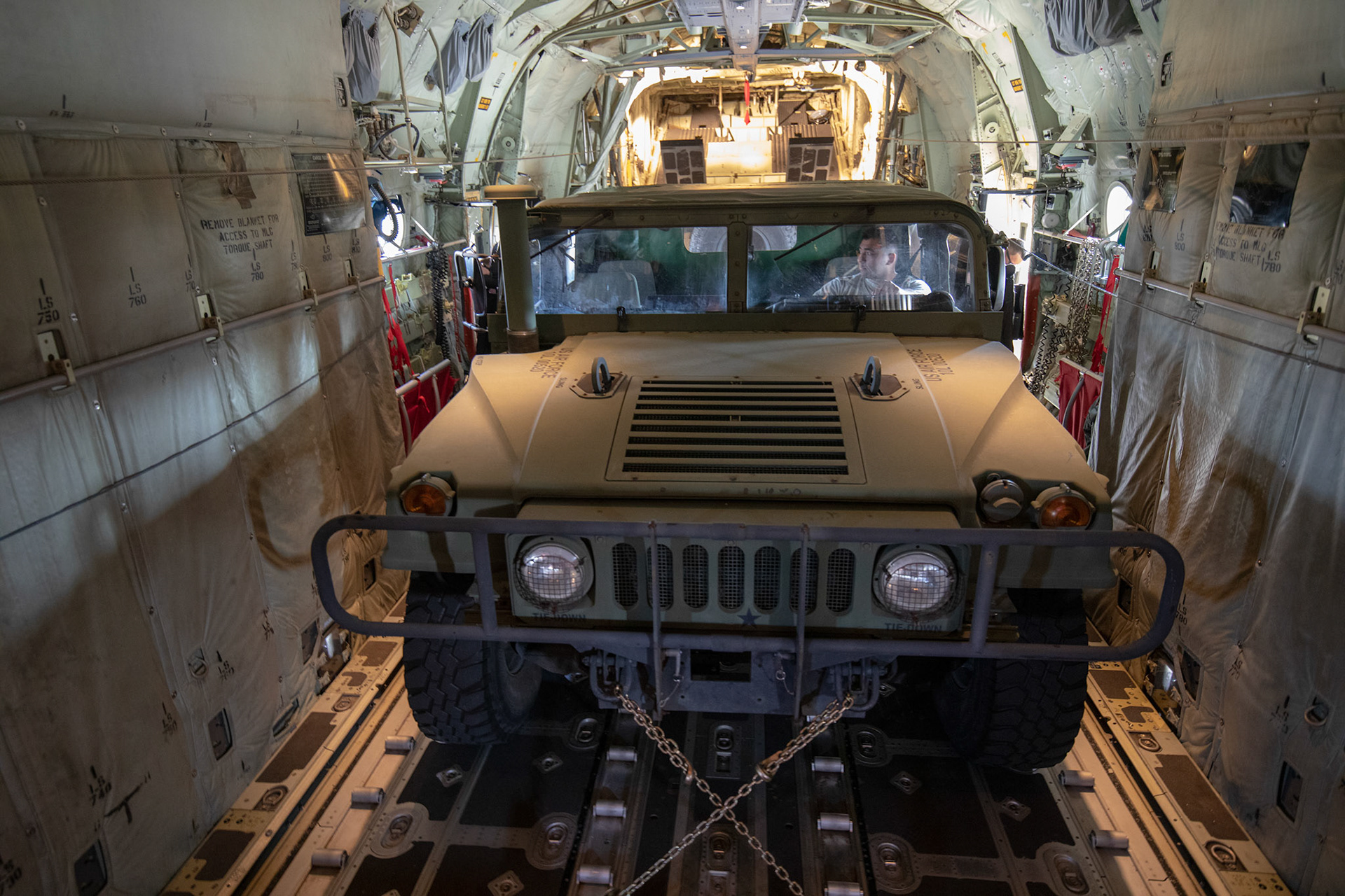 An Air Force Humvee vehicle sits strapped down in a C-130J Super Hercules during the Yokota C-130J Rodeo at Yokota Air Base, Japan, March 22, 2019. Two of six events that make up the Rodeo competition was a reverse taxi and a Humvee vehicle on and off-load which judged both pilots and loadmasters on their ability to successfully complete the tasks. (U.S. Air Force photo by Yasuo Osakabe)