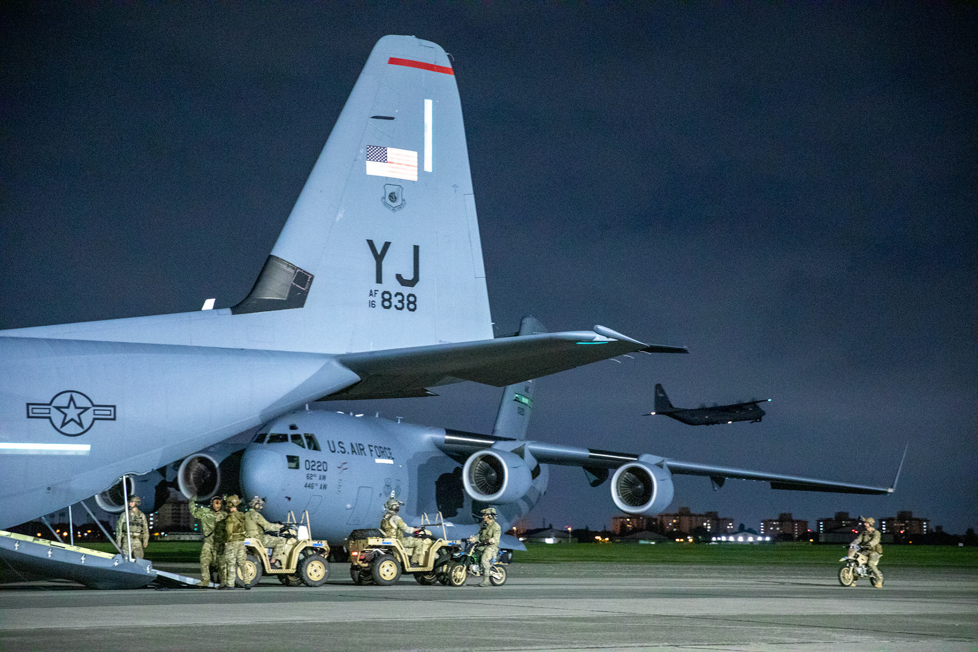 U.S. Air Force Special Tactics operators with the 320th Special Tactics Squadron out of Kadena Air Base, Japan, wait to load their tactical vehicles into a C-130J Super Hercules during an engine running onload/offload (ERO) training as part of Exercise Gryphon Jet at Yokota Air Base, Japan, June 23, 2020. Special Tactics is a U.S. Special Operation Command's tactical air and ground integration force, and the Air Force's special operations ground force, leading Global Access, Precision Strike, Personnel Recovery and Battlefield Surgery operations on the battlefield. Exercise Gryphon Jet is an integrated training exercise focused on improving interoperability throughout the special operations community. (U.S. Air Force photo by Yasuo Osakabe)