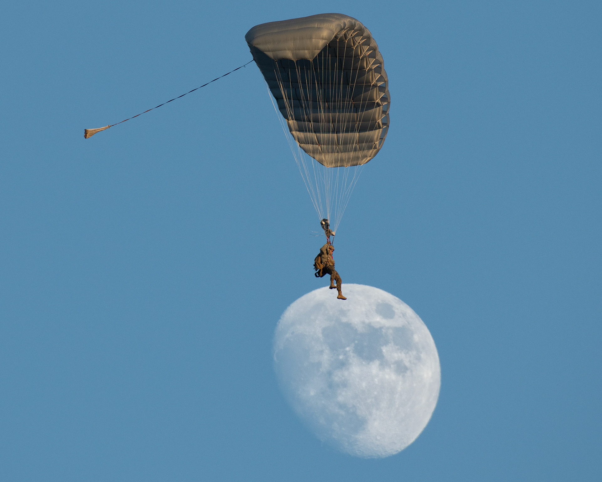A Marine assigned to the 3rd Reconnaissance Battalion, 3rd Marine Division, conducts high altitude, low opening (HALO) parachute jump from an Air Force C-130J Super Hercules assigned to the 36th Airlift Squadron, over Yokota Air Base, Japan, Dec. 13, 2021. U.S. Marines and a U.S. Air Force Survival, Evasion, Resistance and Escape (SERE) specialist conducted week-long jump training using Air Force and Navy aircraft. The training supports the U.S. Indo-Pacific Command’s dynamic force employment (DFE) concept through agile combat employment (ACE), which supports the National Defense Strategy effort to conduct training with joint partners while maintaining global peace and security. (U.S. Air Force photo by Yasuo Osakabe)