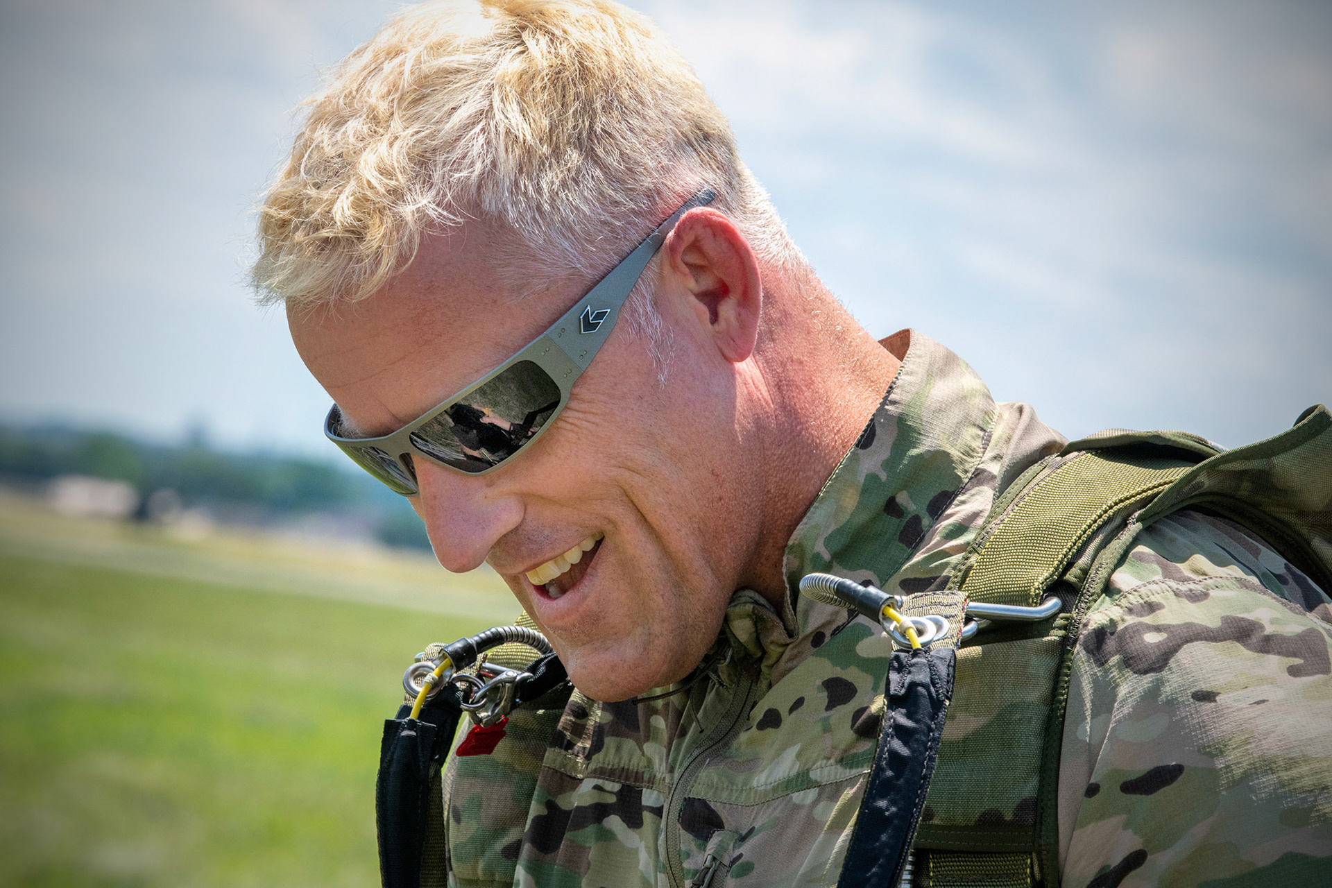 U.S. Air Force Tech. Sgt. Seth Sarrett, 374th Operations Support Squadron survival, evasion, resistance and escape specialist, shows his smile after landing a drop zone during the Japanese-American Friendship Festival at Yokota Air Base, Japan, May 22, 2022. A six member team comprised of U.S. Air Force and JGSDF paratroopers, conducted a military free fall demonstration to show their capabilities during the festival. During the two-day festival, more than 110,000 attendees came to Yokota to experience the event. The festival is aimed at increasing bilateral relationships between U.S. and Japanese communities and allows people to see U.S. and Japanese military capabilities first-hand. (U.S. Air Force photo by Yasuo Osakabe)