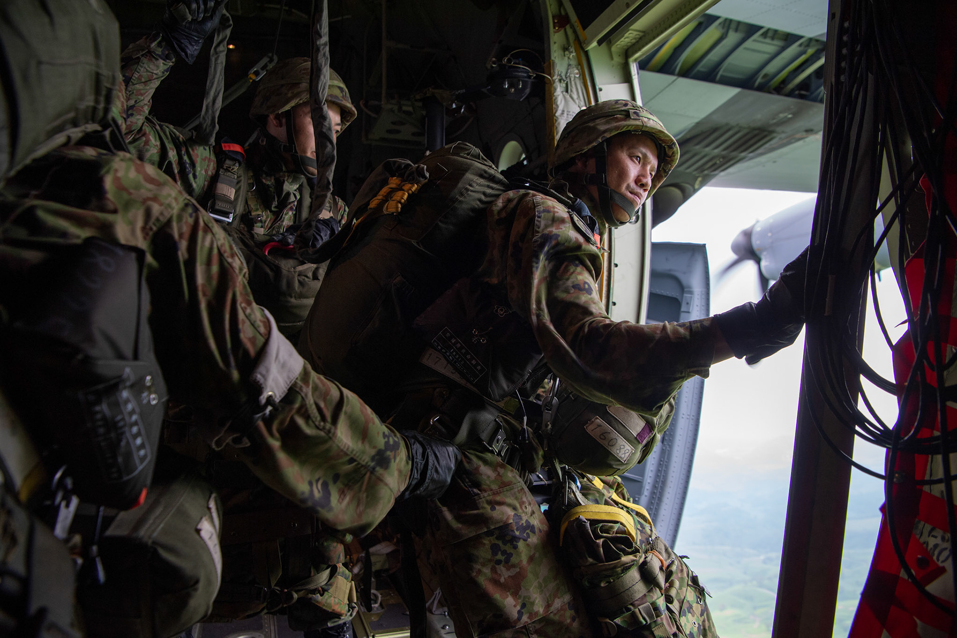 A Japan Ground Self-Defense Force soldier assigned to the 1st Airborne Brigade is ready to jump from a U.S. Air Force C-130J Super Hercules from the 36th Airlift Squadron over Hiju-dai exercise area, Oita prefecture, Japan, July 16, 2019. The training allows USAF and JGSDF units to work alongside each other while improving the readiness of our armed forces. (U.S. Air Force photo by Yasuo Osakabe)