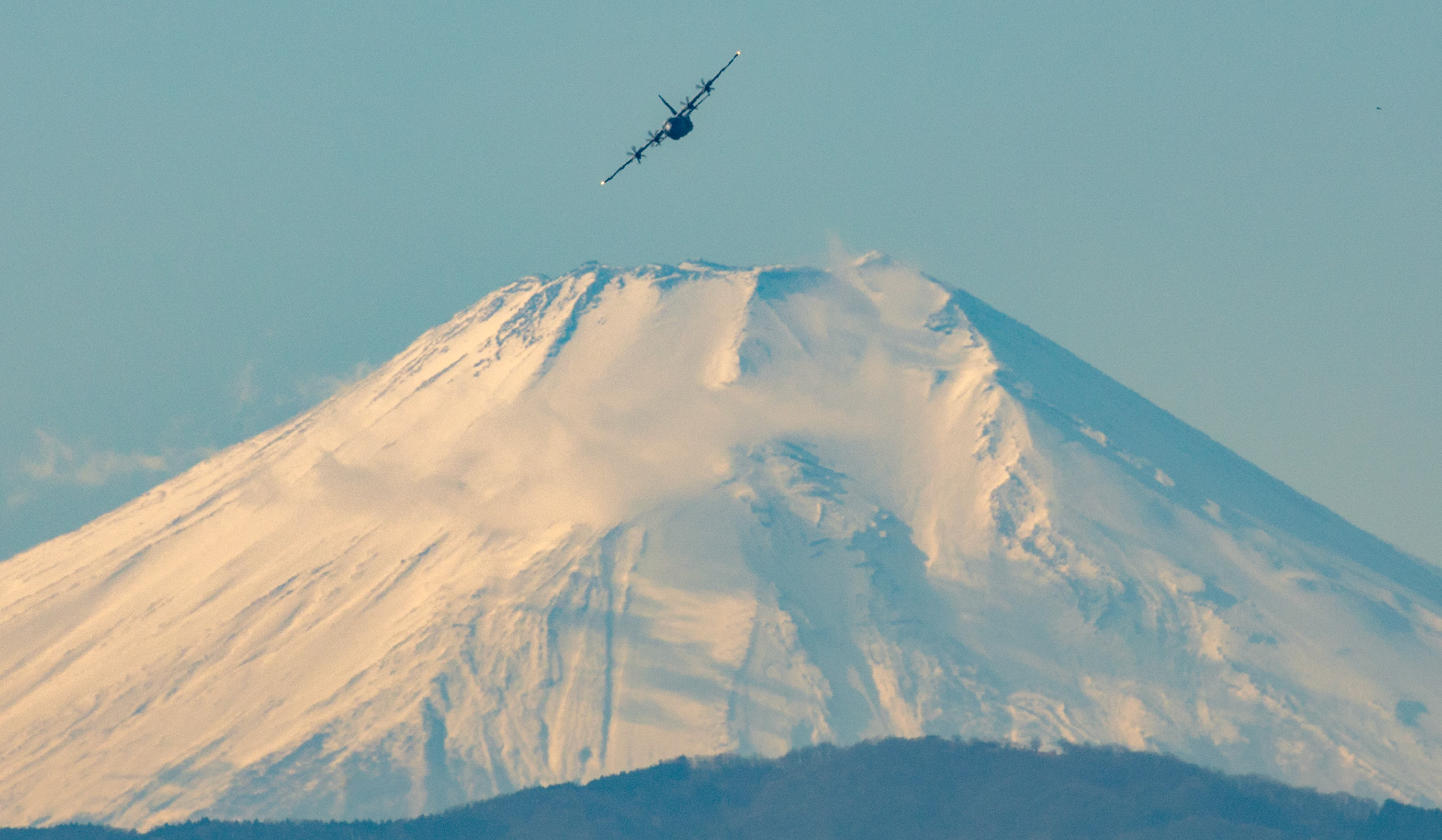 A C-130J Super Hercules assigned to the 36th Airlift Squadron fries nearby Mt. Fuji, Japan, during a routine sortie, Jan. 12, 2018 at Yokota Air Base, Japan. The 36 AS regularly conducts training missions to remain proficient in the necessary skills to support any contingency. (U.S. Air Force photo by Yasuo Osakabe)