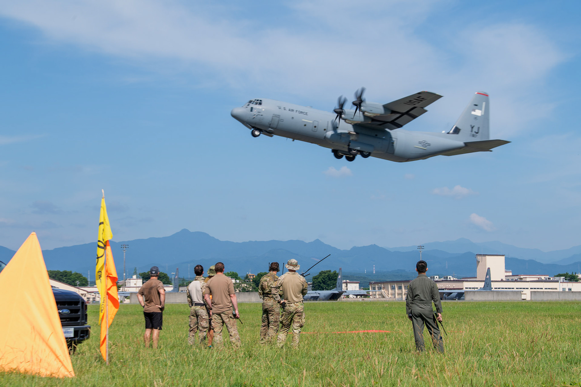 U.S. Special Operations Forces members observe a U.S. Air Force C-130J Super Hercules assigned to the 36th Airlift Squadron takeoff at Yokota Air Base, Japan, June 17, 2020, during Exercise Gryphon Jet. Gryphon Jet is an integrated training exercise focused on improving interoperability throughout the special operations community. (U.S. Air Force photo by Yasuo Osakabe)