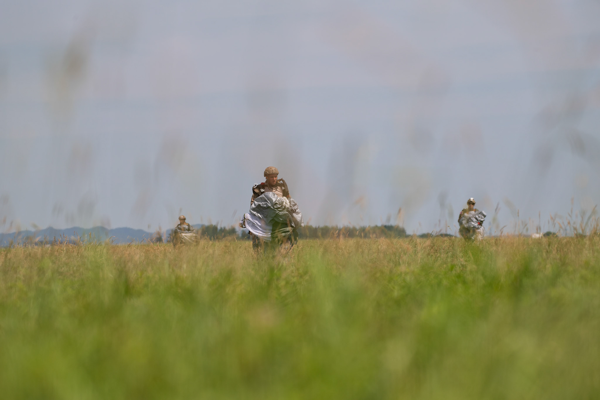U.S. Navy SEALs (Sea, Air and Land) Team One carry their parachutes and gears after conducting a high altitude low opening jump during Exercise Gryphon Jet at Yokota Air Base, Japan, June 17, 2020. Gryphon Jet is an integrated training exercise focused on improving interoperability throughout the special operations community. (U.S. Air Force photo by Yasuo Osakabe)