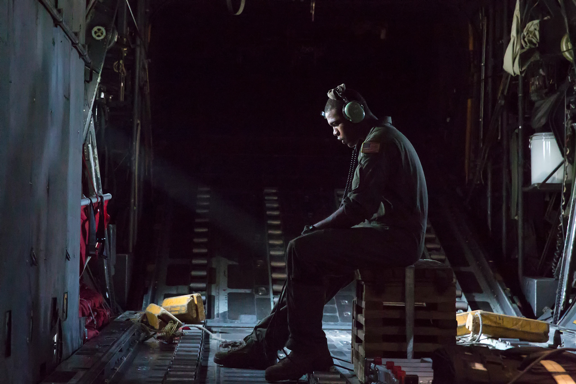 Airman 1st Class Wynthom Thomas, 36th Airlift Squadron loadmaster, communicates with pilots after landing Yokota Air Base, Japan, Aug. 19, 2013. Seven C-130s flew in formation practicing airlift tactics and procedures. (U.S. Air Force photo by Osakabe Yasuo)