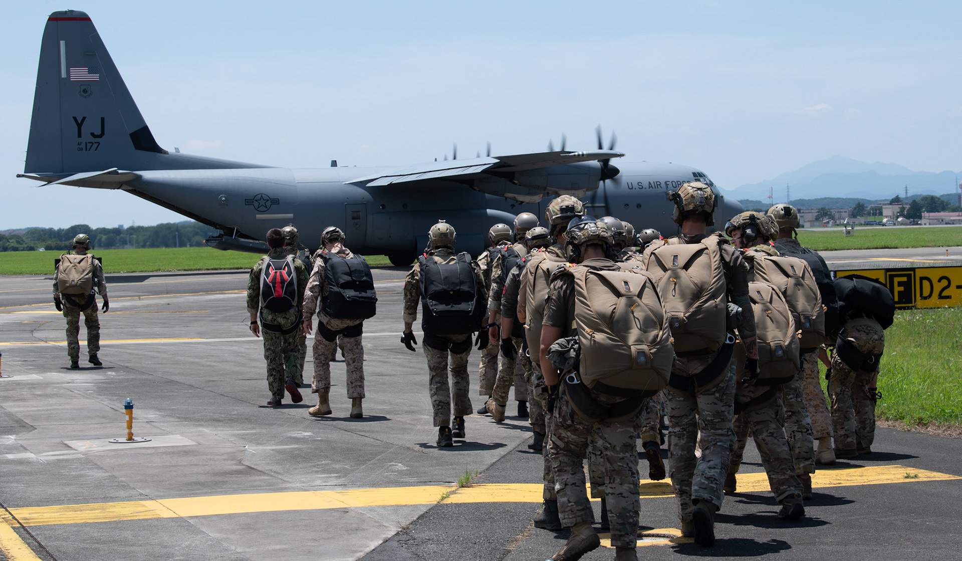 U.S. Special Operations Forces members walk to board a C-130J Super Hercules assigned to the 36th Airlift Squadron during Exercise Gryphon Jet at Yokota Air Base, Japan, June 17, 2020. Gryphon Jet is an integrated training exercise focused on improving interoperability throughout the special operations community. (U.S. Air Force photo by Yasuo Osakabe)