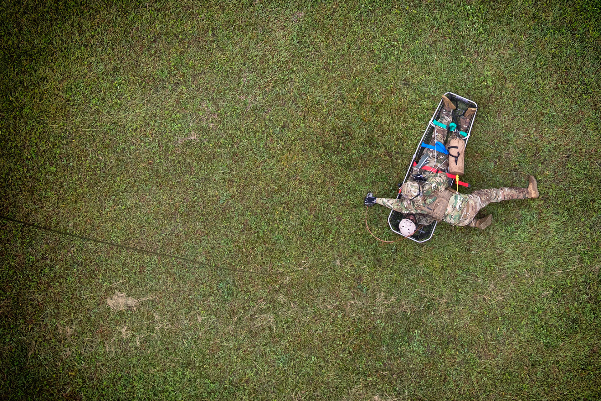 Tech. Sgt. Justin Bender, 374th Operations Support Squadron survival, evasion, resistance and escape specialist, secures a simulated victim to a stokes stretcher during a Capabilities Exercise as part of the 2018 Japanese-American Friendship Festival at Yokota Air Base, Japan, Sept. 15, 2018. Members with the 459th AS showcased their rescue capabilities to execute search-and-rescue mission. (U.S. Air Force photo by Yasuo Osakabe)