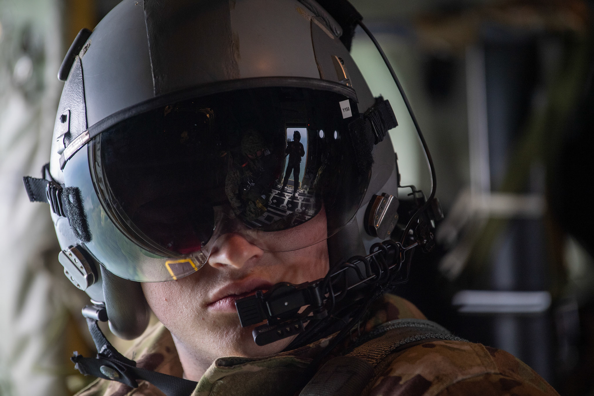 U.S. Air Force Senior Airman William Griffin, 36th Airlift Squadron loadmaster, communicates with his crewmembers over Hiju-dai exercise area, Oita prefecture, Japan, July 16, 2019, during a bilateral jump training. The training allows USAF and JGSDF units to work alongside each while improving the readiness of our armed forces. (U.S. Air Force photo by Yasuo Osakabe)