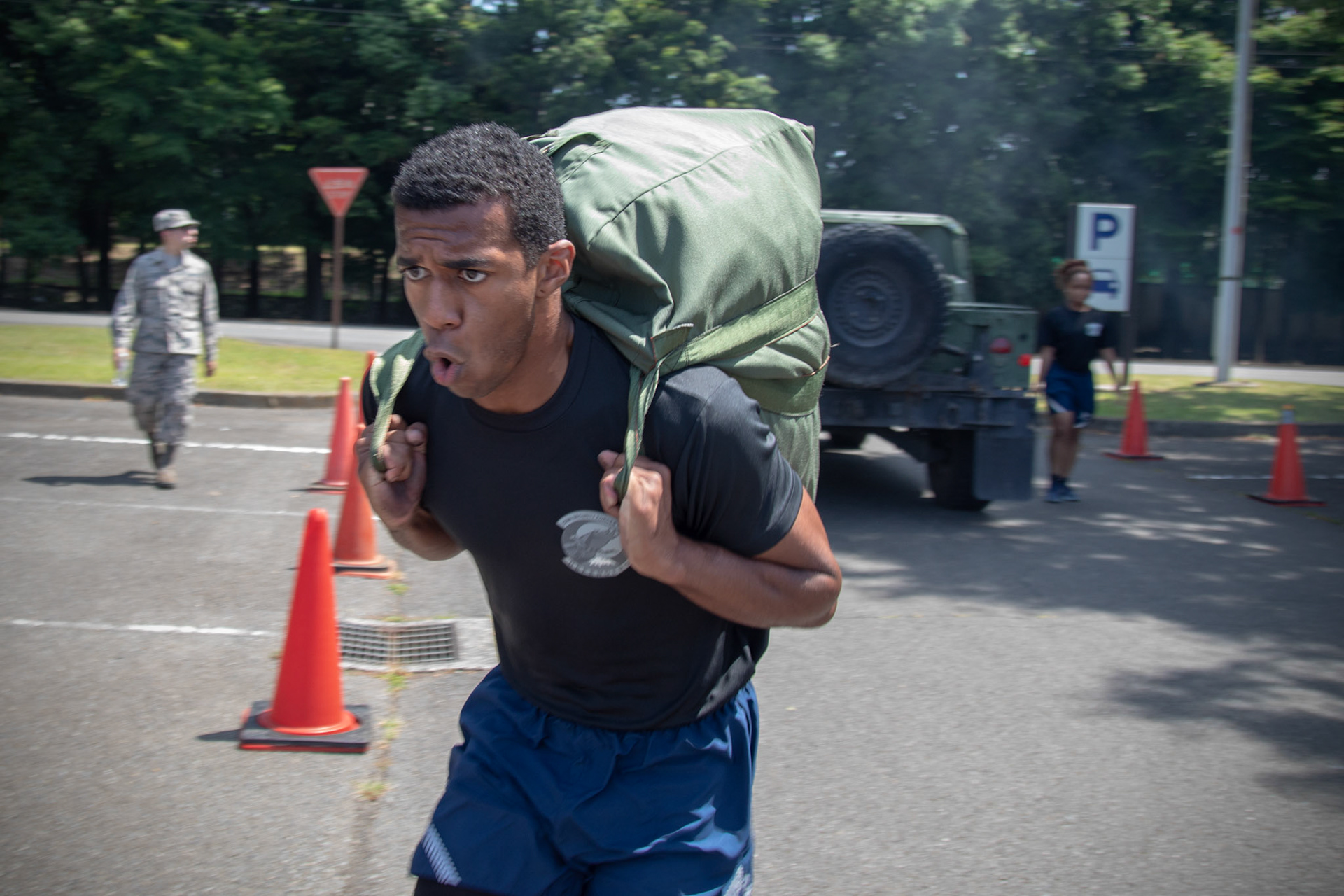 Senior Airman Antonio Gant, 374th Security Forces Squadron armorer, carries his chemical gear bag during an Ability to Survive and Operate (ATSO) Rodeo at Yokota Air Base, Japan, June 8, 2018. The rodeo involved participants wearing different stages of mission-oriented protective posture (MOPP) gear after pushing a Humvee and going through various areas of training including self-aid and buddy care, post-attack reconnaissance, four-person relay, and "shoot, move and communicate." (U.S. Air Force photo by Yasuo Osakabe)
