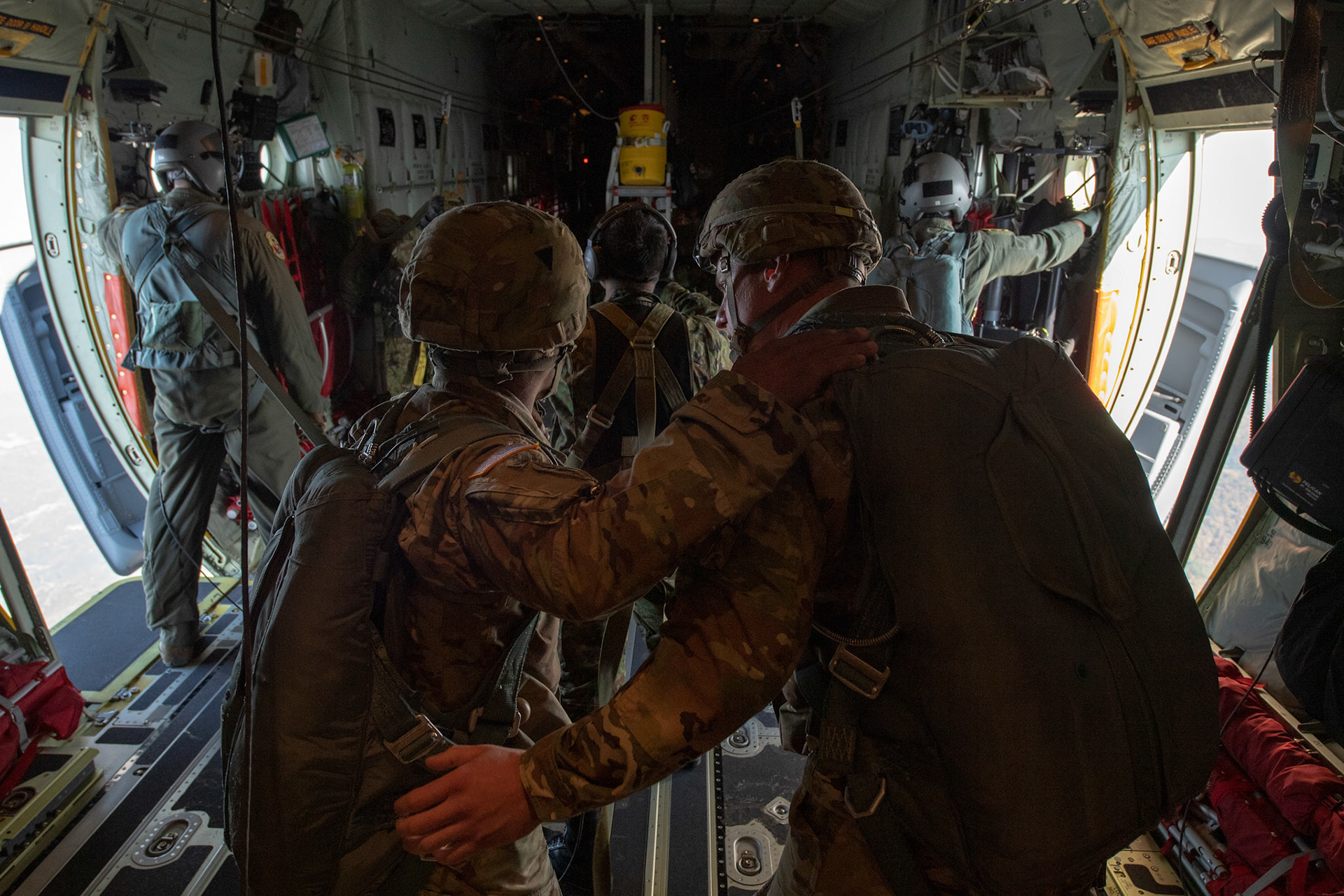 (Right to left) U.S. Army Master Sgt. Nathan Greer and Staff Sgt. Kevin Stewart, both with the U.S. Army Alaska jump masters, talk after supporting Japan Ground Self-Defense Force soldiers jumps from a C-130J Super Hercules assigned to the 36th Airlift Squadron over Hiju-dai drop zone, Oita prefecture, Japan, Nov. 4, 2018, during Keen Sword 19. Approximately 280 JGSDF personnel conducted jump training from U.S. Air Force C-130J Super Hercules’ for the first time in Japan. (U.S. Air Force photo by Yasuo Osakabe)