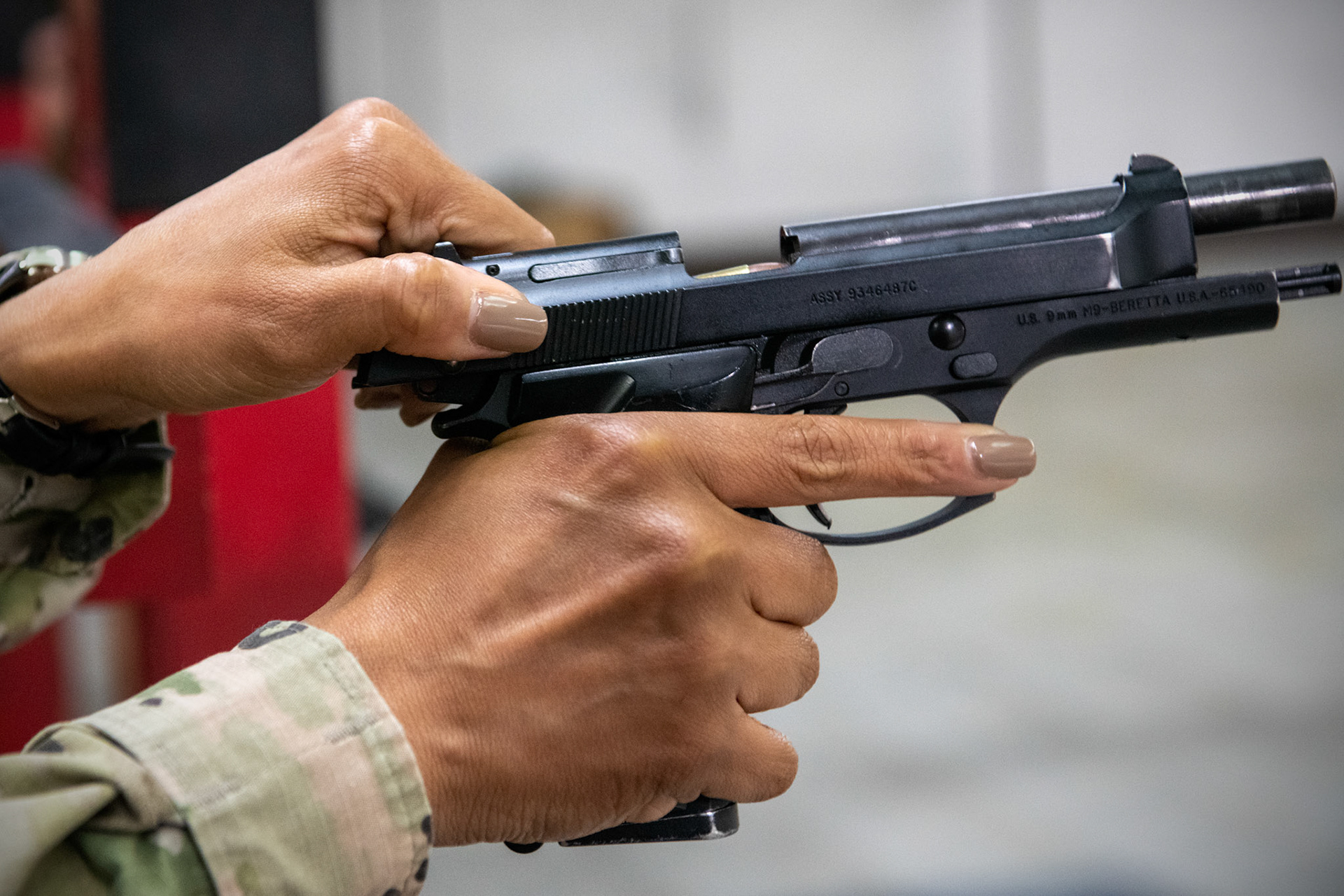 Chief Master Sgt. Tiffany Griego, 374th Mission Support Group senior enlisted leader, performs a function check during an Excellence-In-Competition M9 Beretta pistol event at Yokota Air Base, Japan, April 12, 2022. The four-day competition was held to boost morale and test 165 active-duty military members on how accurate they can shoot their authorized duty pistols. The top 10% scorers will earn the Air Force Excellence In Competition medal to wear on the Service Dress Uniform. (U.S. Air Force photo by Yasuo Osakabe)