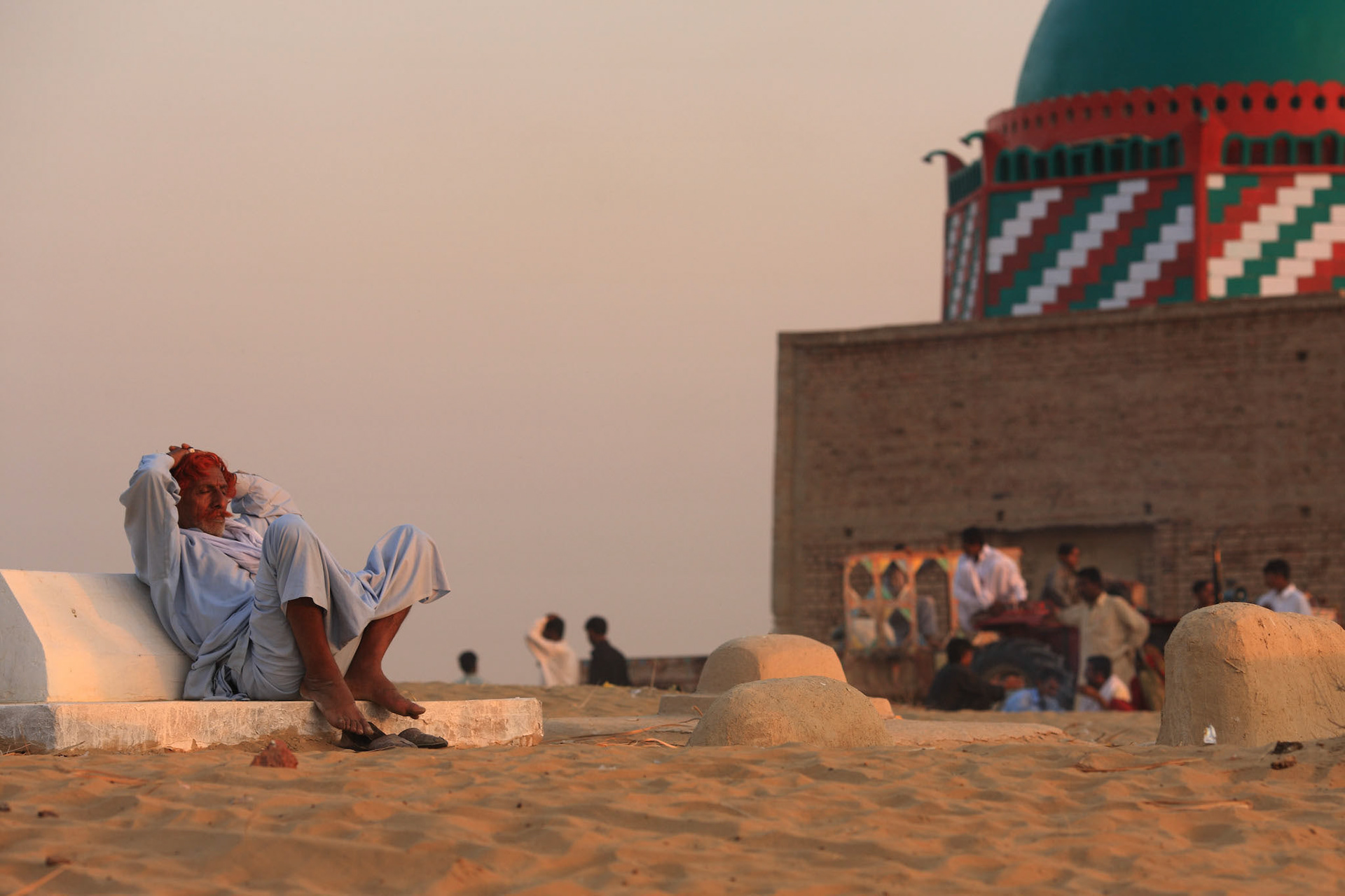 A man sit down on the graveyard and felt the evening breeze. (Travel)