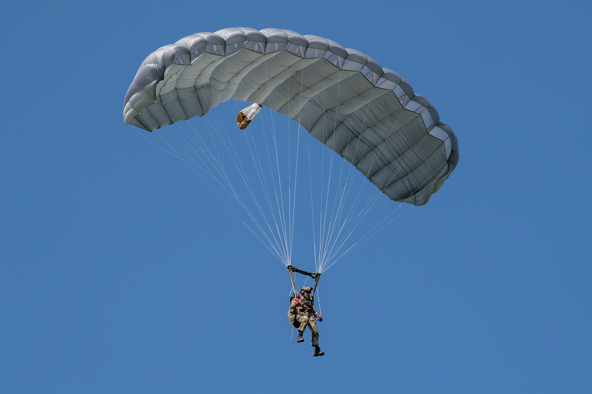 A member of U.S. Navy SEAL (Sea, Air and Land) Team One parachutes from a U.S. Air Force C-130J Super Hercules assigned to the 36th Airlift Squadron over Yokota Air Base, Japan, June 17, 2020, during Exercise Gryphon Jet. Gryphon Jet is an integrated training exercise focused on improving interoperability throughout the special operations community. (U.S. Air Force photo by Yasuo Osakabe)