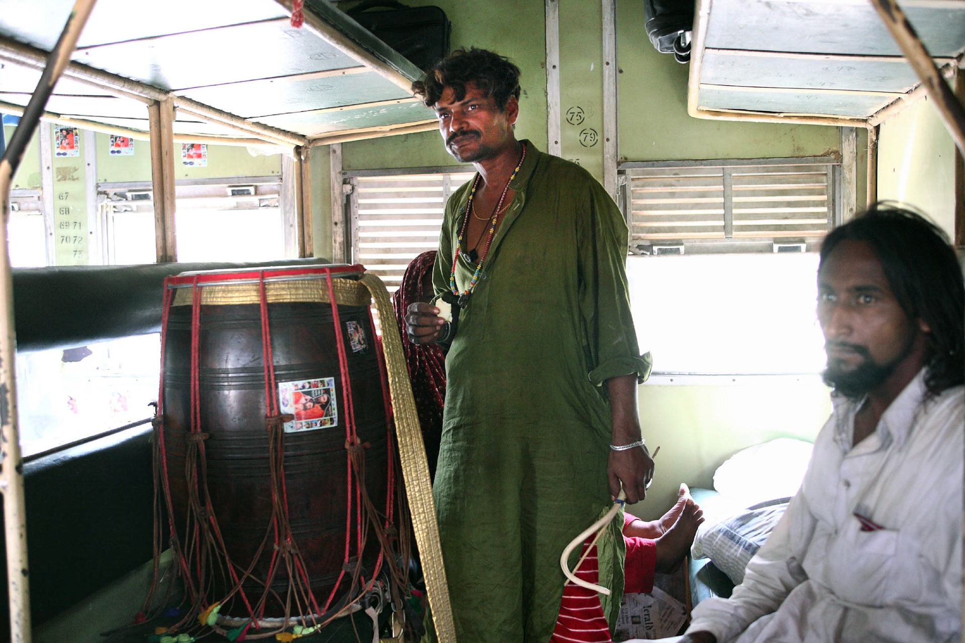 Jhura sain (sufi dhol player) was waiting to play the sufi beat for the passengers under a scorching hot during standing time. (Travel)
