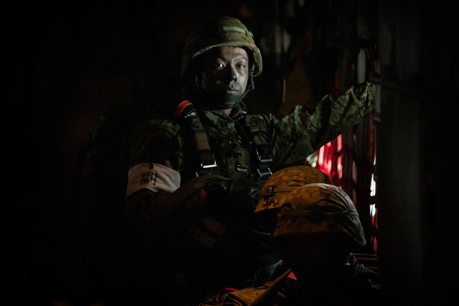 A Japan Ground Self-Defense Force solider assigned to the 1st Airborne Brigade performs personnel accountability on a U.S. Air Force C-130J Super Hercules at Japan Air Self-Defense Force Tsuiki Air Base, Japan, Nov. 4, 2018, during Keen Sword 19. Air Force C-130J Super Hercules’ from the 36 AS became the first U.S. aircraft to drop JGSDF soldiers on Hiju-dai drop zone, Oita prefecture, Japan. (U.S. Air Force photo by Yasuo Osakabe)