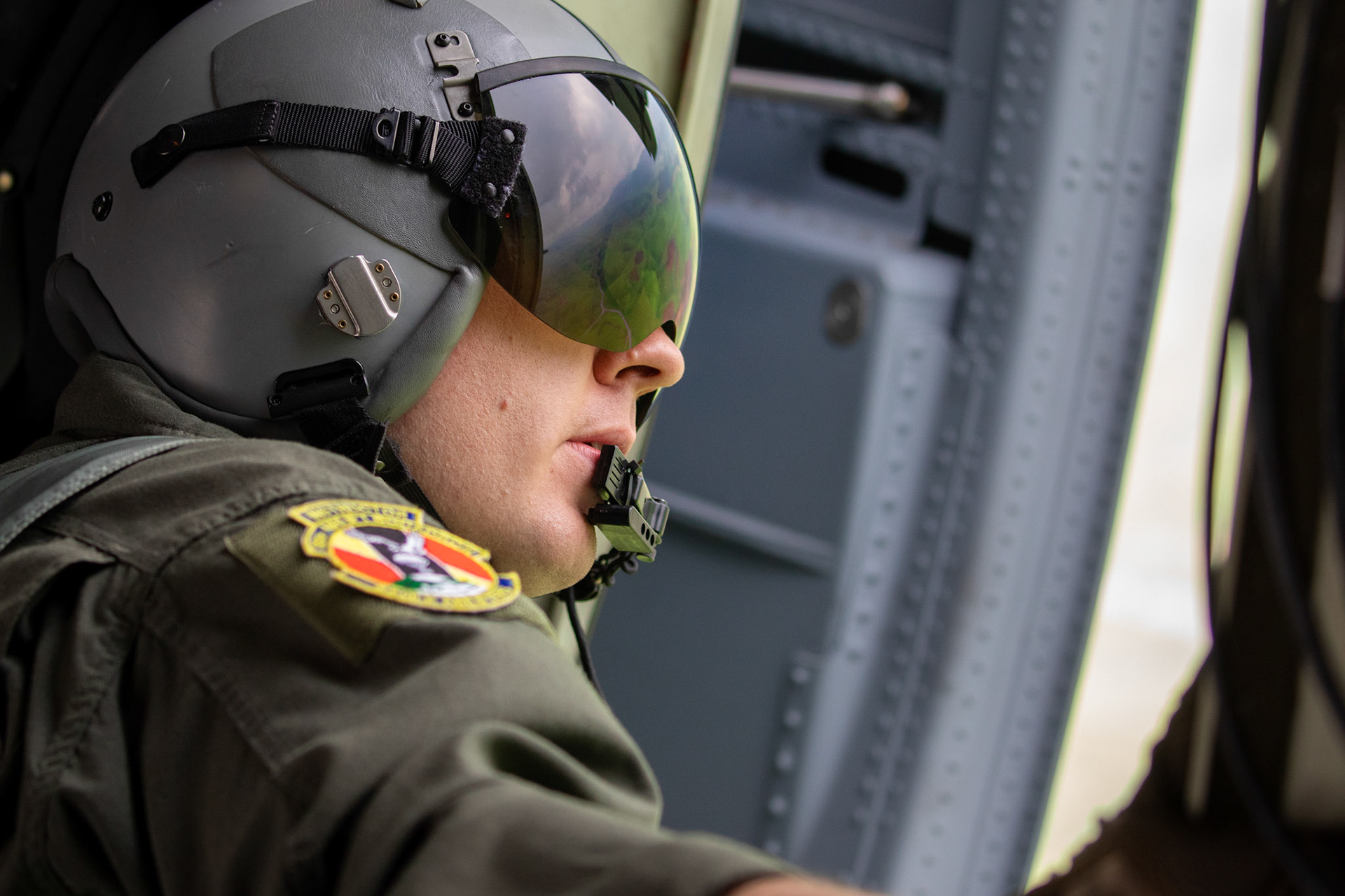 U.S. Air Force Master Sgt. James Huntsman, 36th Airlift Squadron loadmaster, performs a visual confirmation after Japan Ground Self-Defense Force paratroopers assigned to the 1st Airborne Brigade jump from a U.S. Air Force C-130J Super Hercules over Hiju-dai exercise area, Oita prefecture, Japan, July 16, 2019, during a bilateral jump training. The training allows USAF and JGSDF units to work alongside each other while improving the readiness of our armed forces. (U.S. Air Force photo by Yasuo Osakabe)
