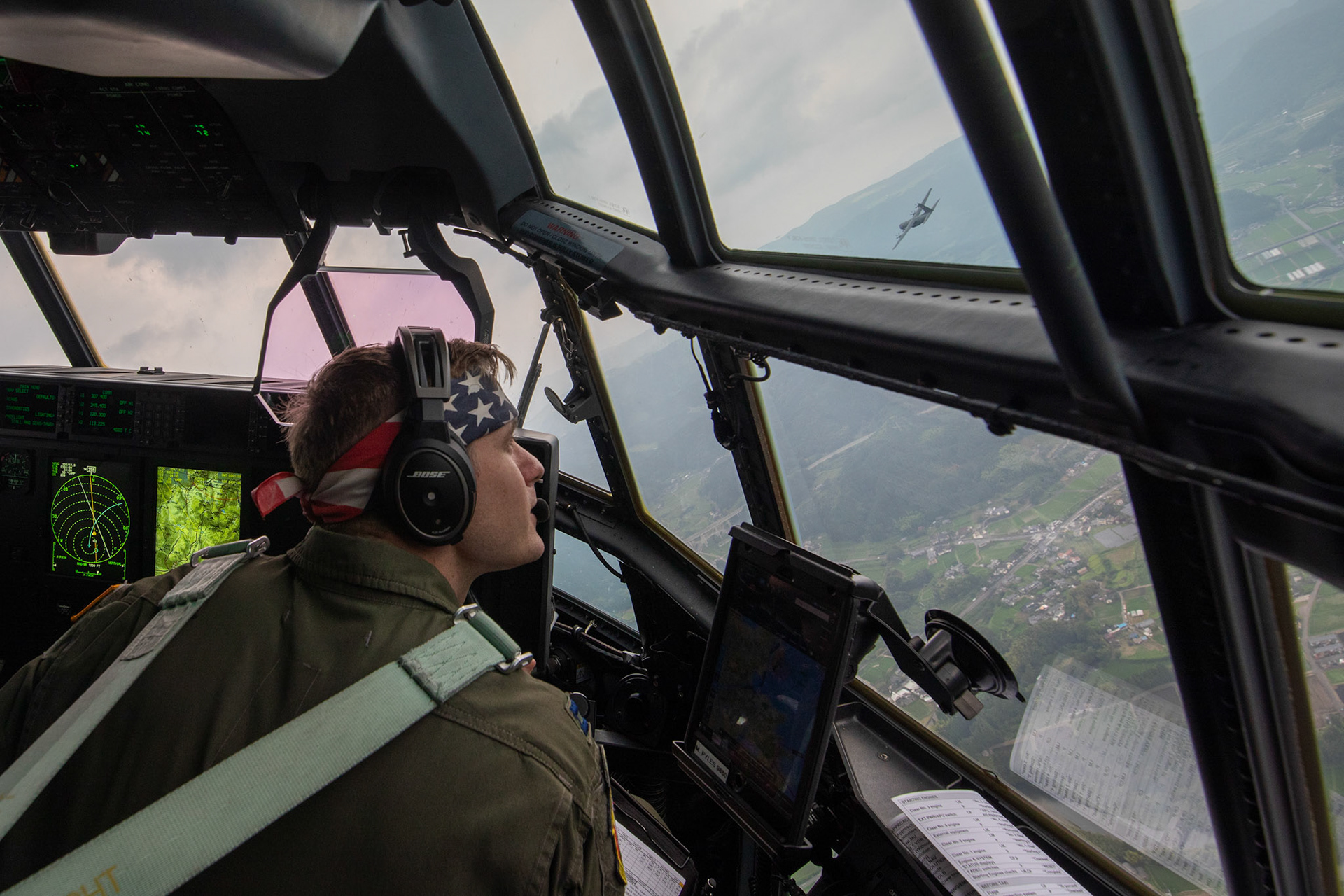 U.S. Air Force Capt. Michael Pyles, 36th Airlift Squadron C-130J pilot, performs a visual confirmation over Mount Aso, Japan, July 16, 2019, during a flight training mission. The training allows USAF and JGSDF units to work alongside each other while improving the readiness of our armed forces. (U.S. Air Force photo by Yasuo Osakabe)