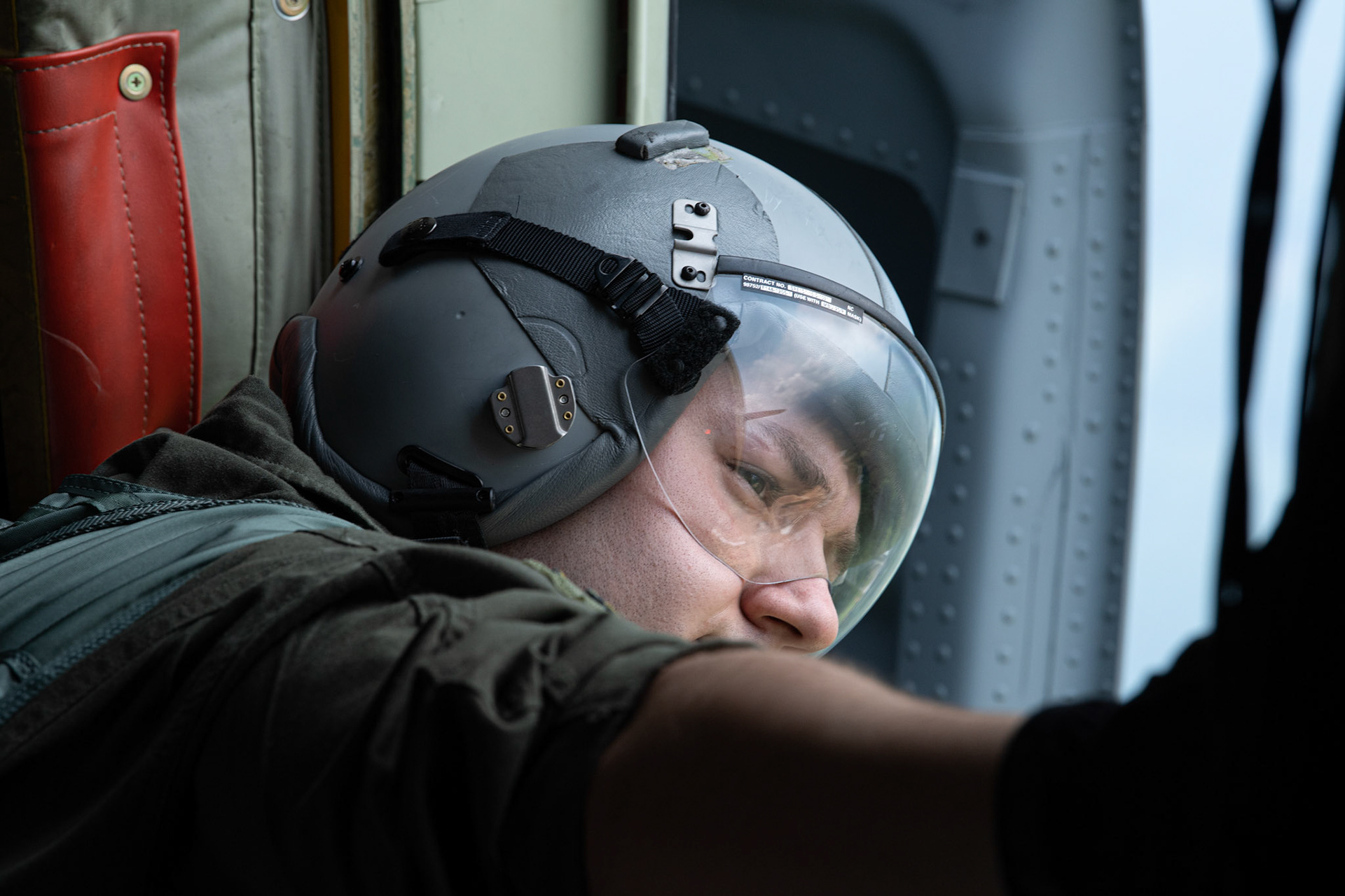 U.S. Air Force Senior Airman Sean Simard, 36th Airlift Squadron loadmaster, performs a visual confirmation over Hiju-dai exercise area, Oita prefecture, Japan, July 16, 2019, during a bilateral jump training. The training allows USAF and JGSDF units to work alongside each other while improving the readiness of our armed forces. (U.S. Air Force photo by Yasuo Osakabe)