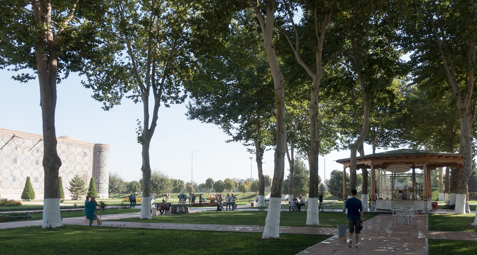 Samarkand: Registan. A contast of styles - you can just make out a woman on left using a  broom, whilst the  man in centre uses a blower.
