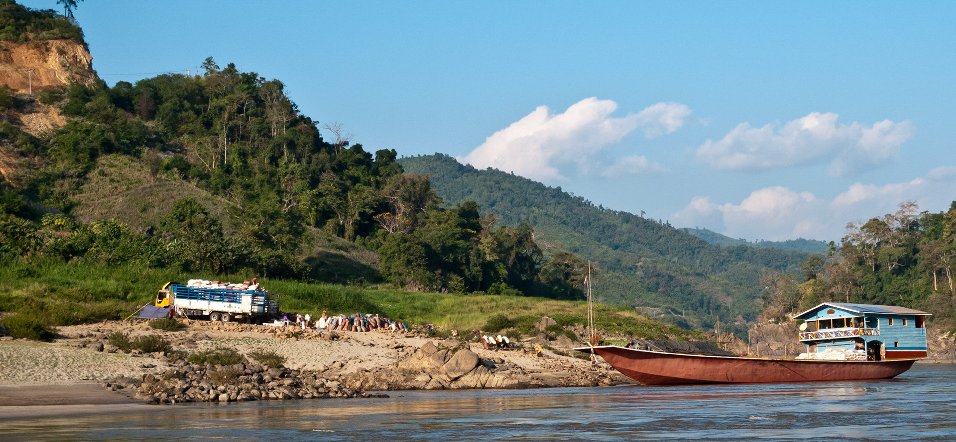 Houei Xai to Louang Prabang: Two days down the Mekong - manual loading of Cargo boat.