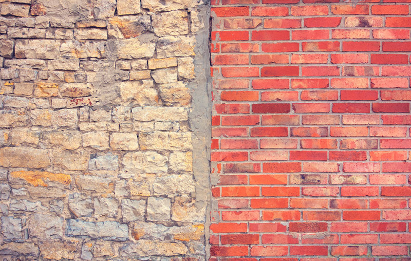 Two walls of a different construction type are meeting themselves. It is an interesting composition of colors and details.