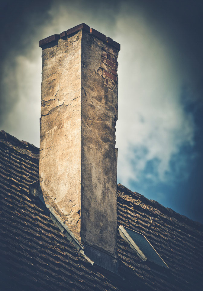 The old abandoned chimney in a dark setting.