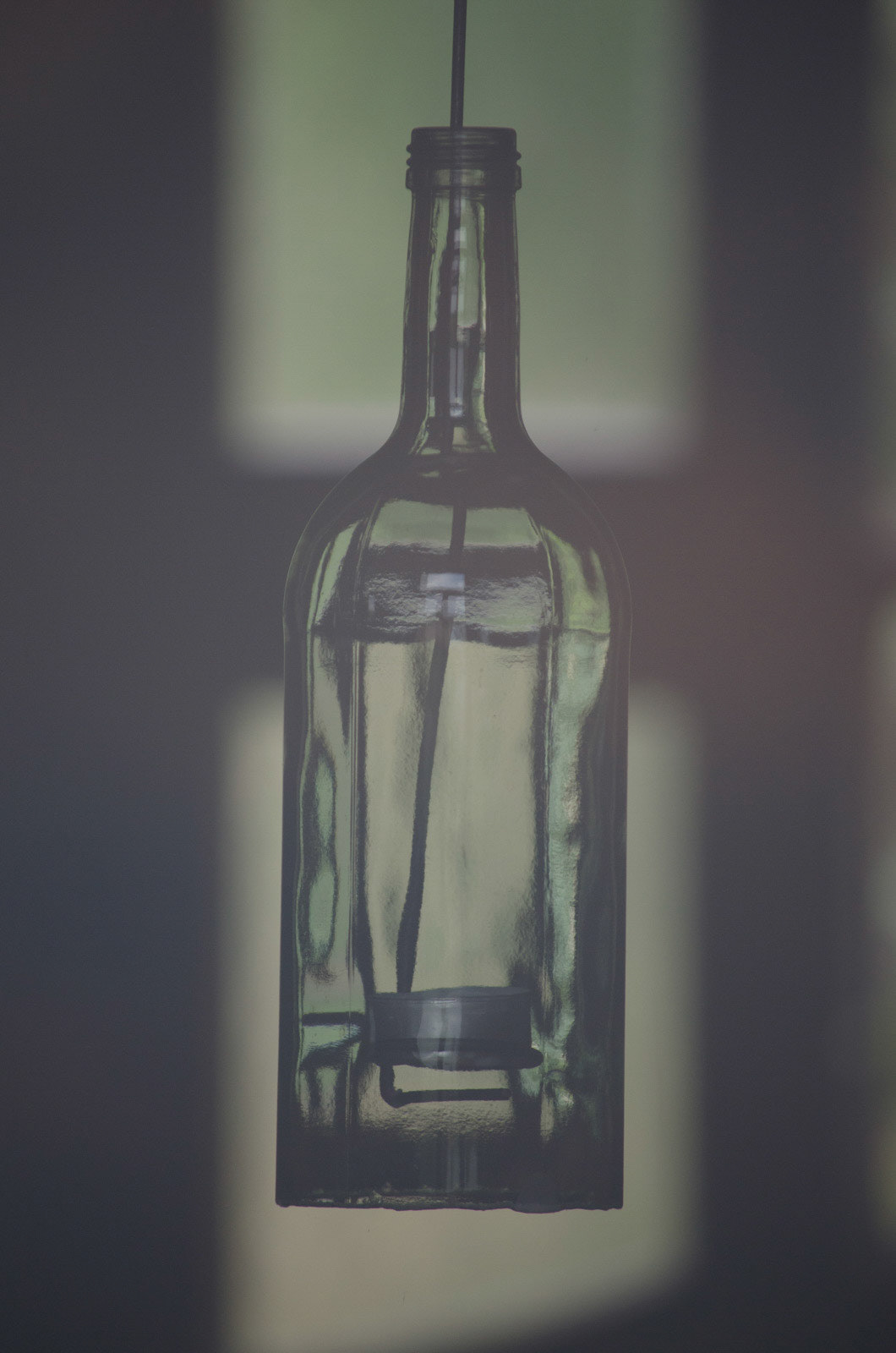 This bottle was photographed behind a glass window. Behind this bottle is a glass window too. The bottle is made of glass. All I see is glass. ;)